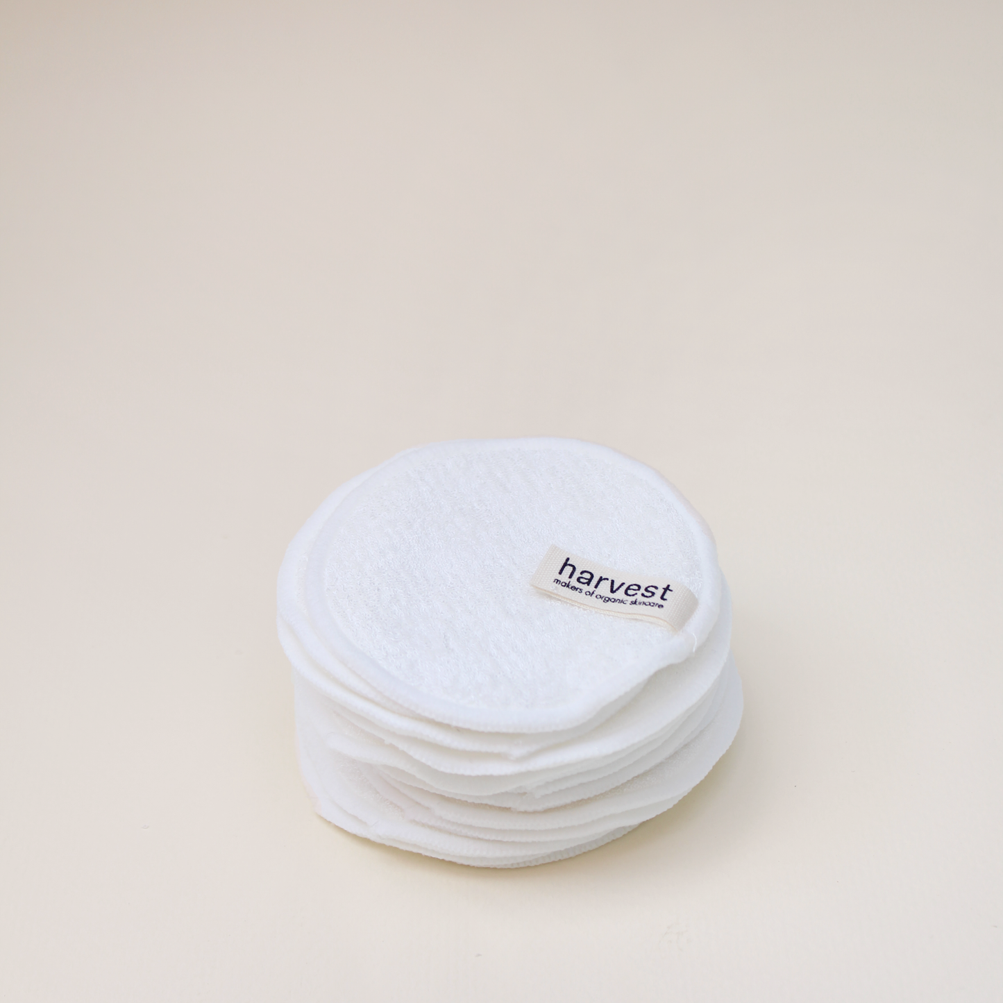 Stack of Harvest reusable organic cotton facial pads with branded label