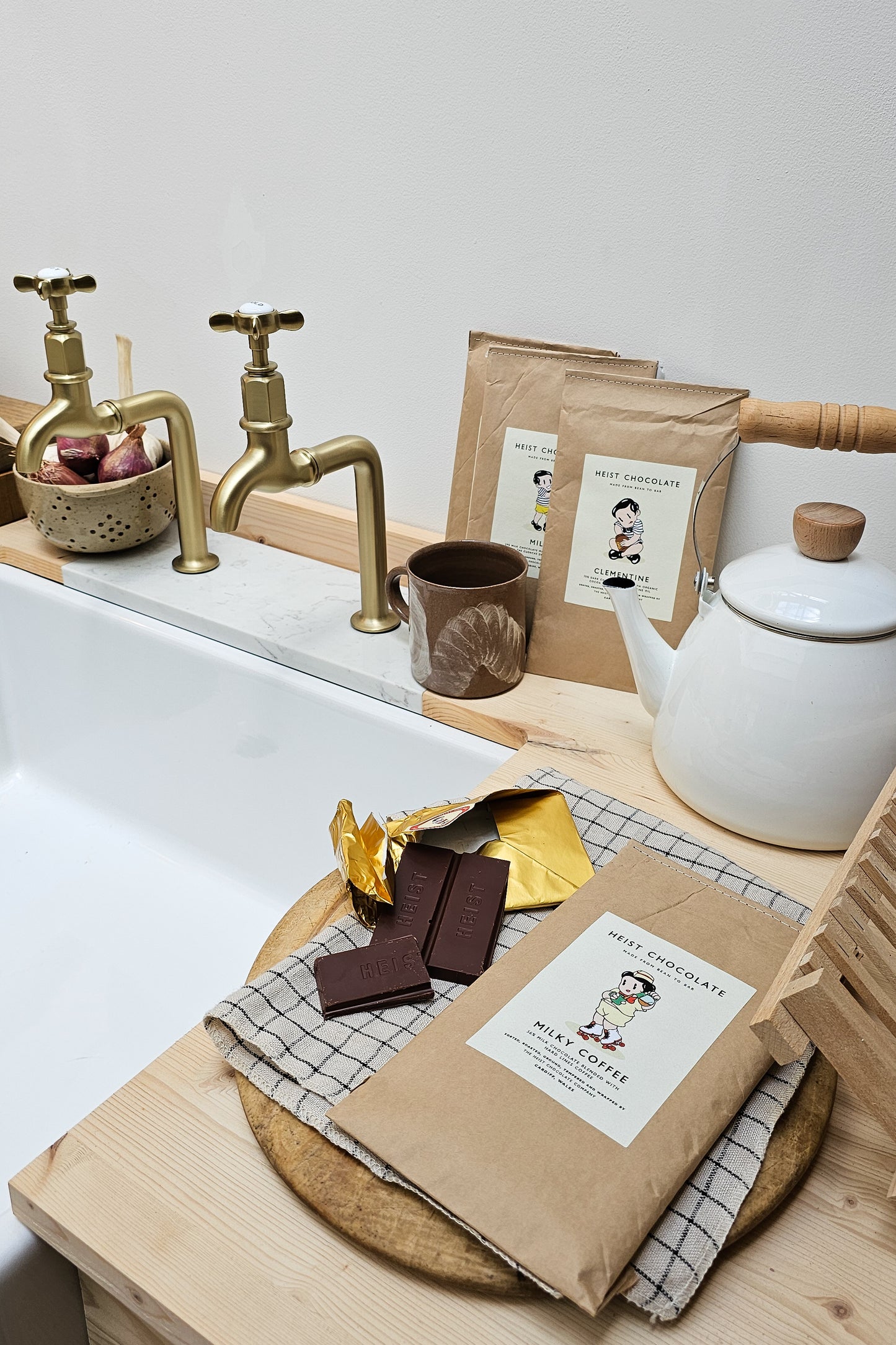 Baking ingredients and tools on a kitchen counter with a focus on chocolate.