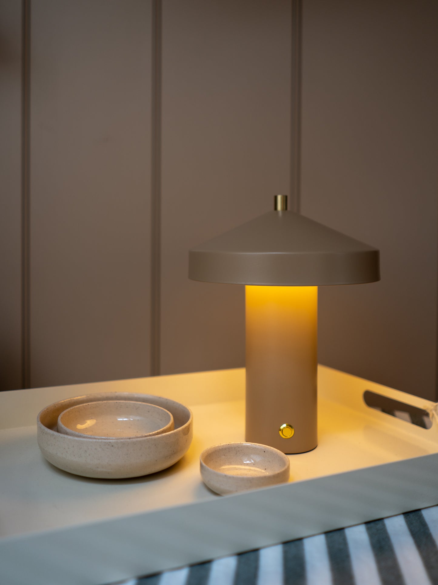 Ceramic lamp and bowls on a table with a neutral background