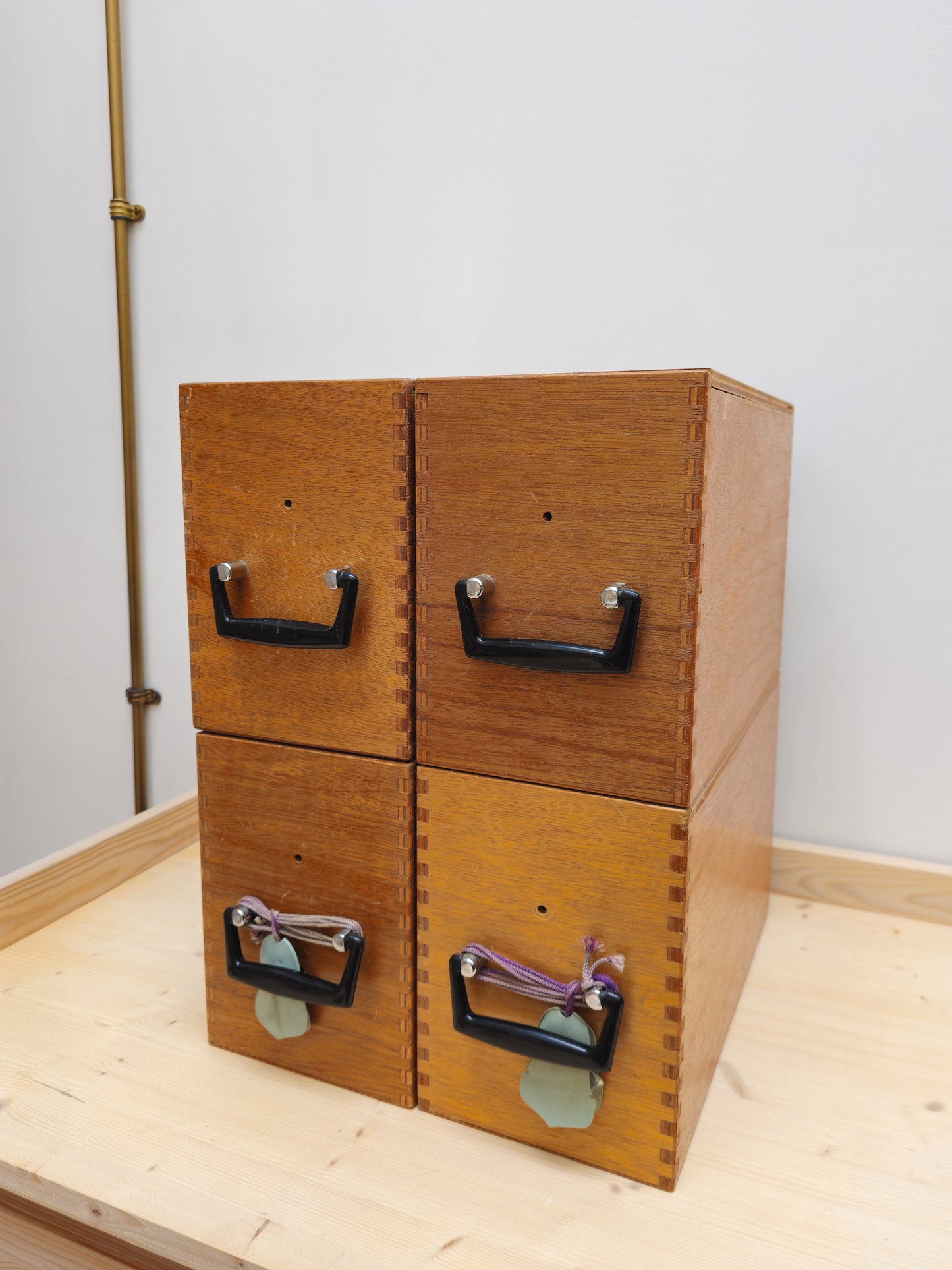 Vintage wooden microscope storage boxes on a light wooden surface.