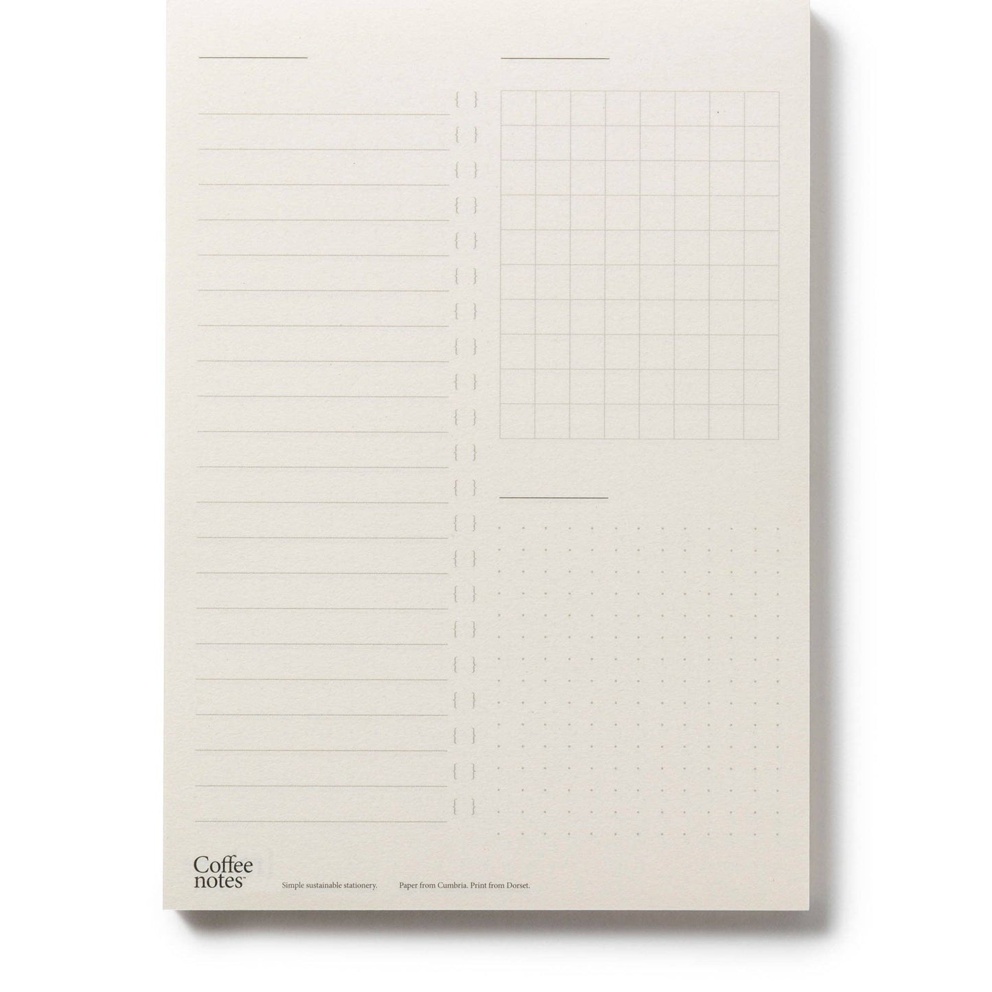 Notebook with lined and grid pages on a plain background.