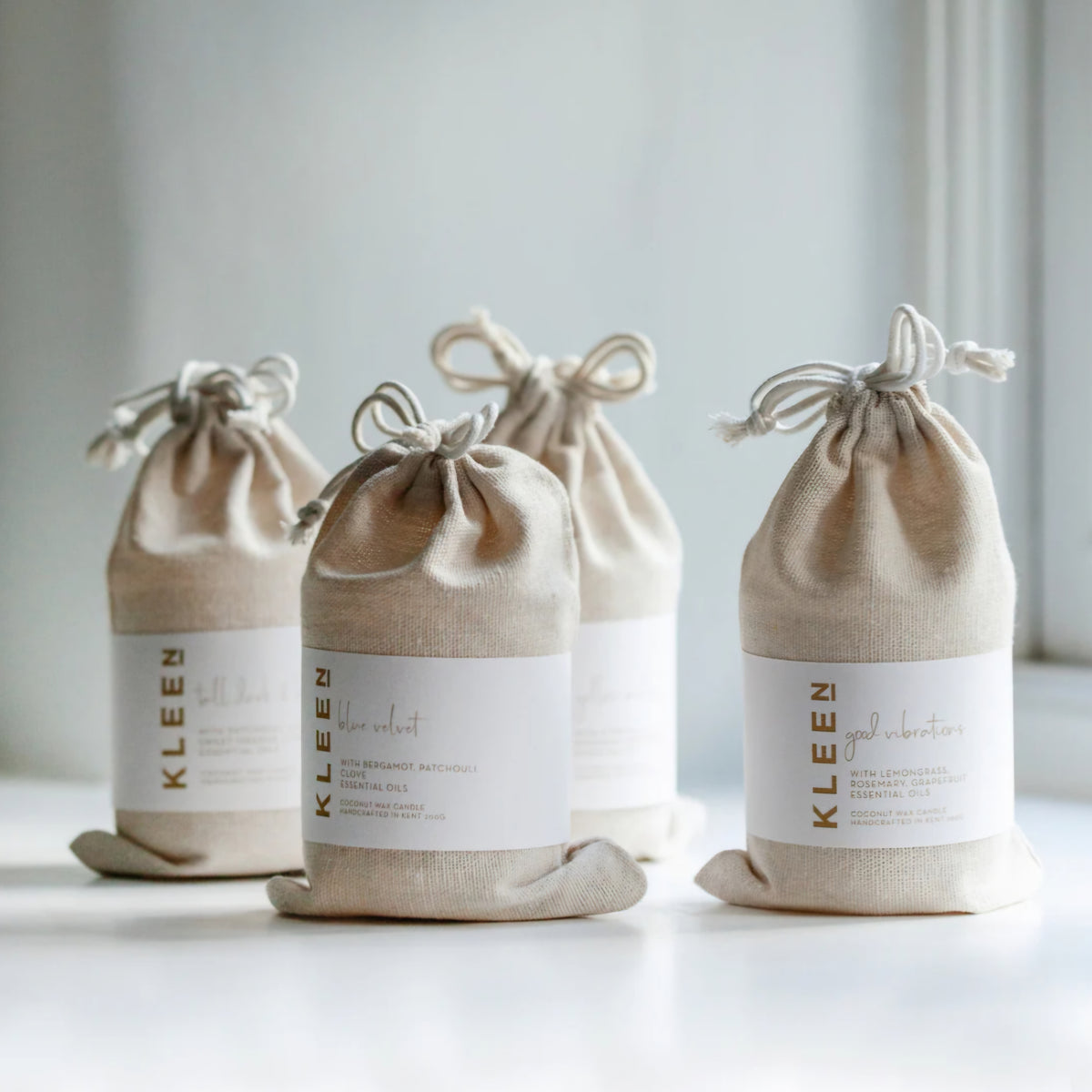 Kleensoaps candle collection in cotton drawstring bags including Yellow Mellow, Blue Velvet and Good Vibrations