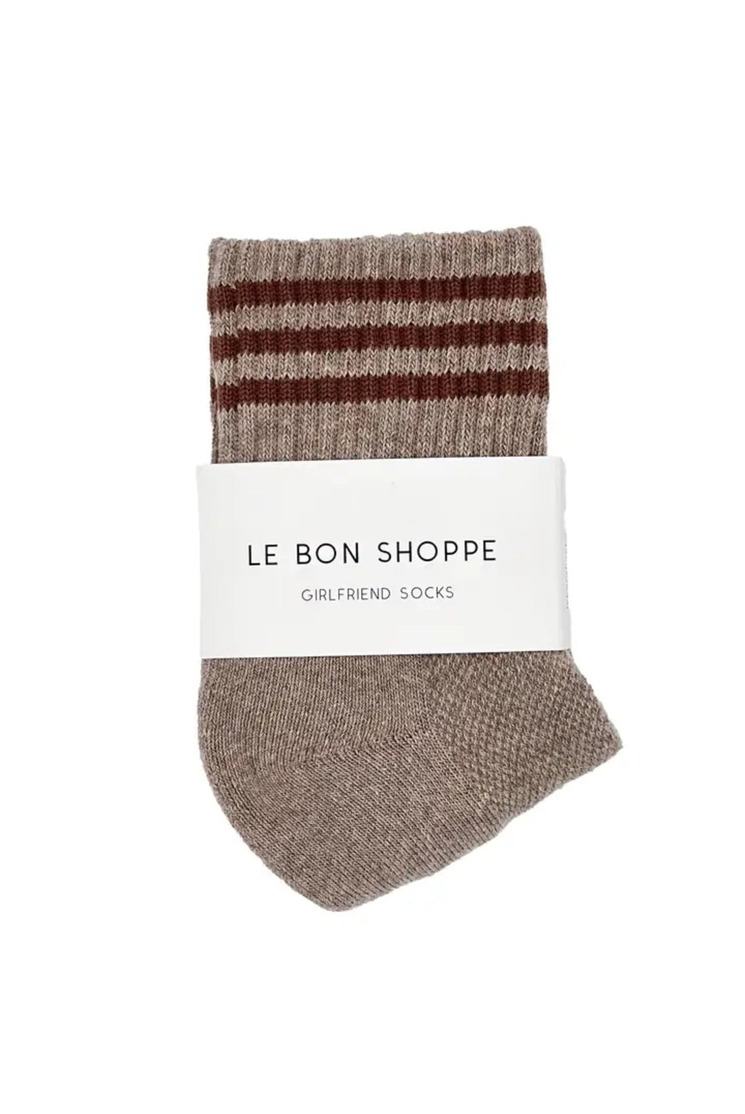 Pair of light brown socks with red stripes on a white background.