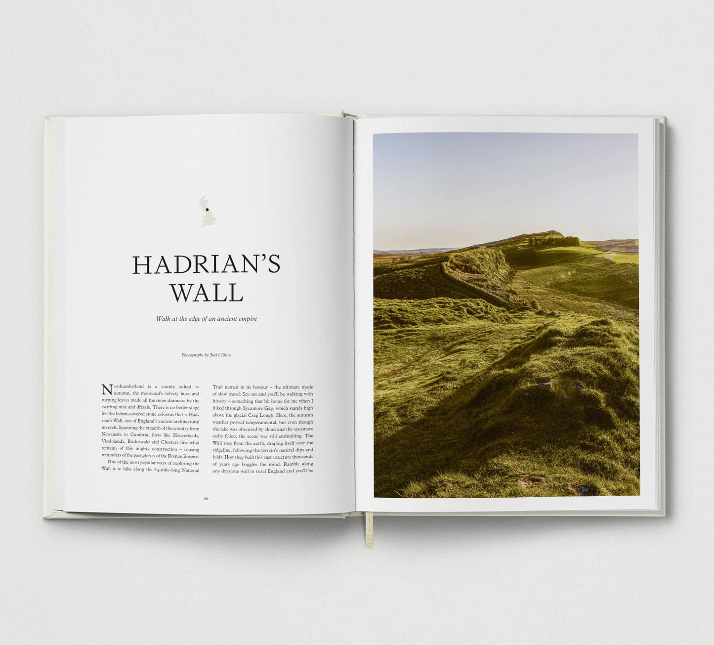 Open book showing a page with text and an image of Hadrian's Wall.