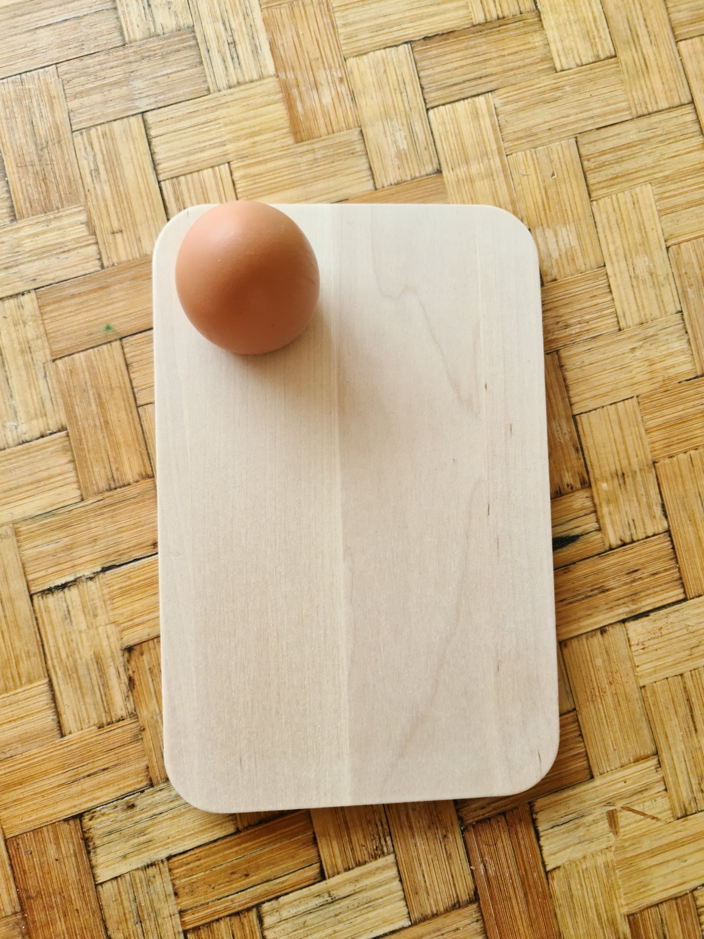 Birch sandwich platter with an egg resting in its hole.