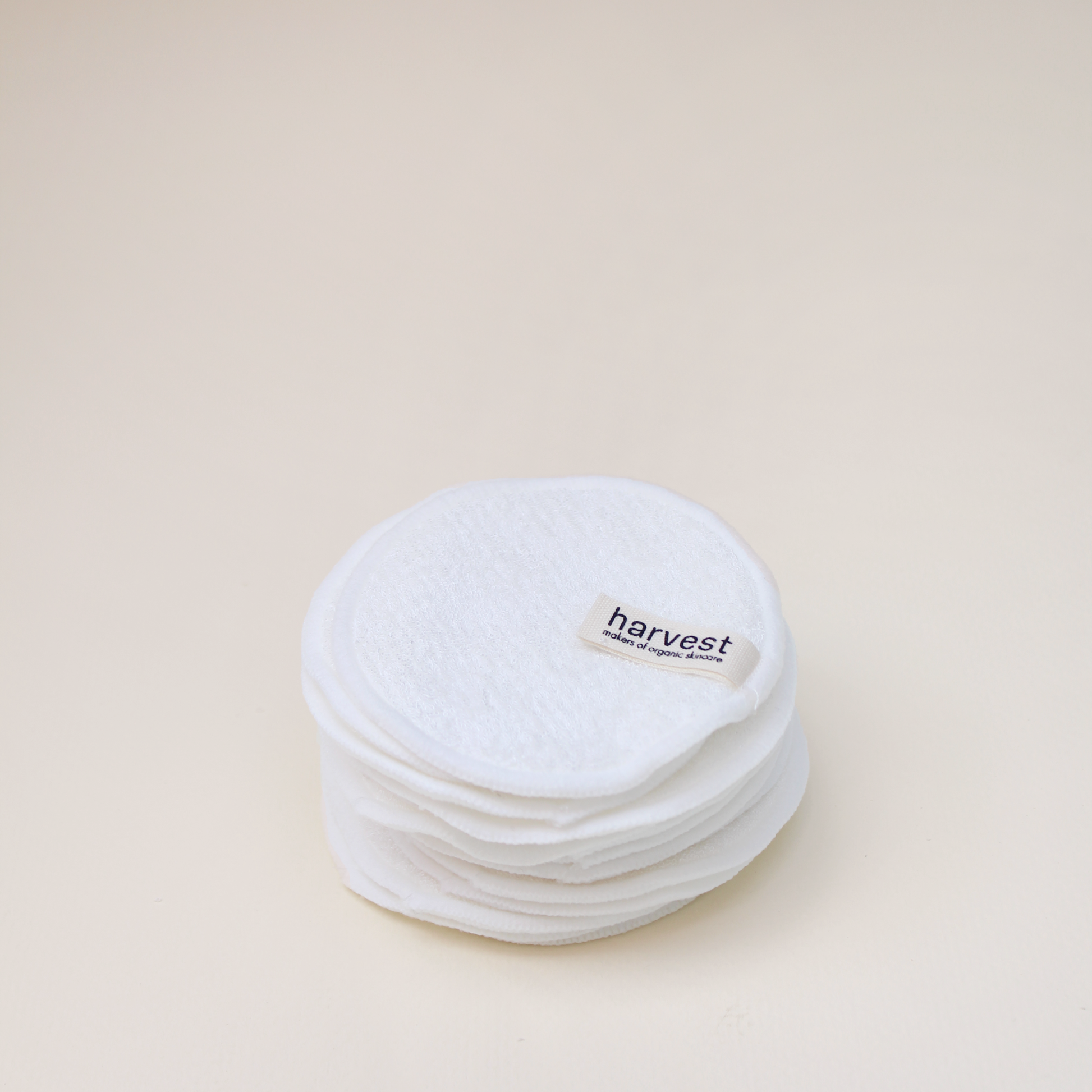 Stack of Harvest reusable organic cotton facial pads with branded label