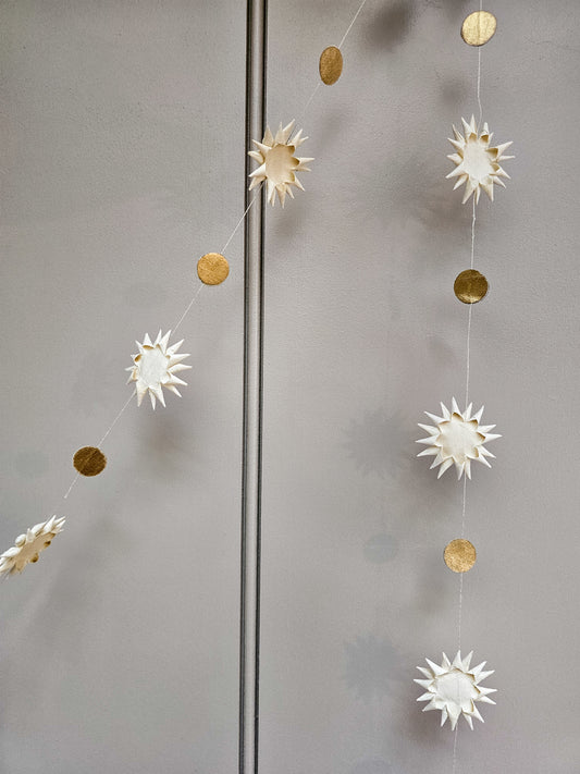 Decorative garland with paper starsgold accents on a gray background