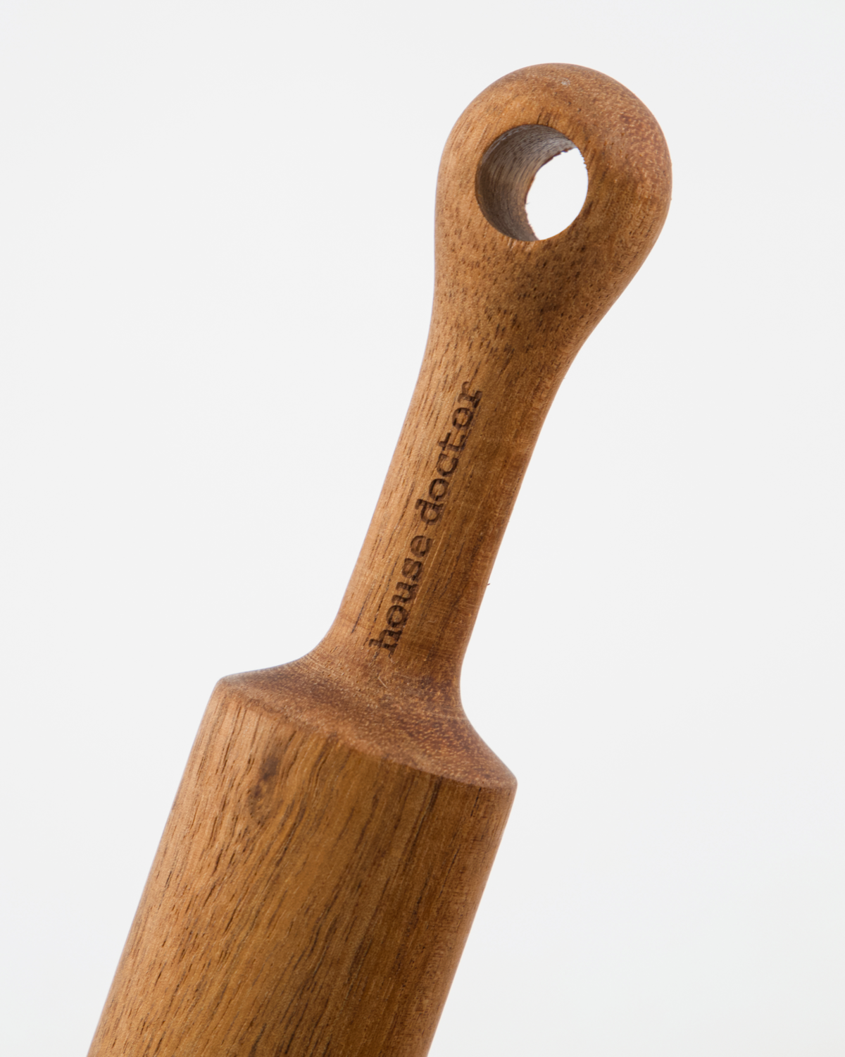 Wooden rolling pin handle with 'house doctor' branding on a white background