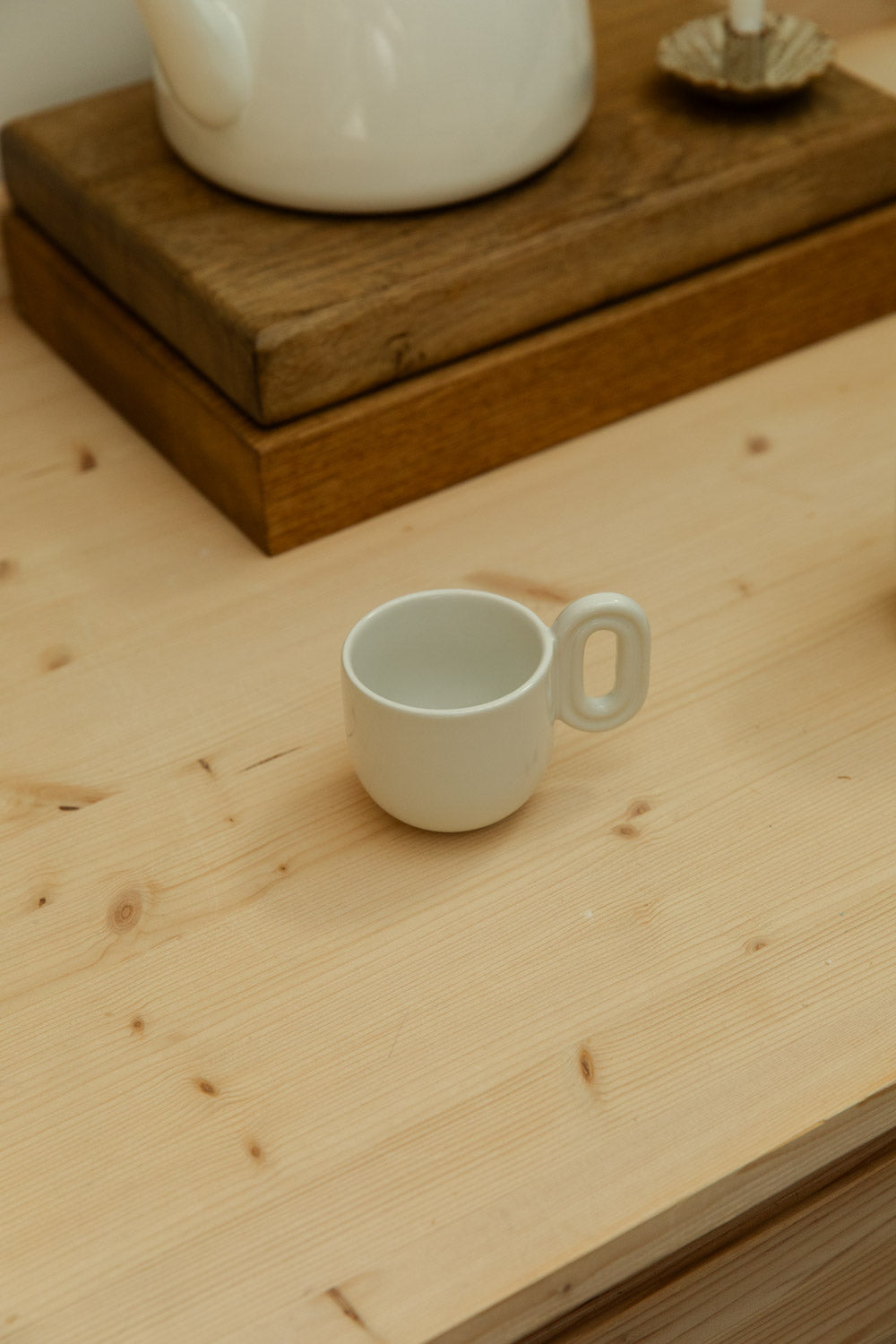 White ceramic mug on a wooden surface