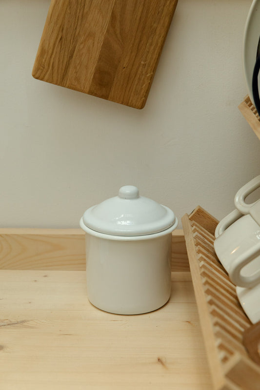 White enamel canister on wooden kitchen worktop