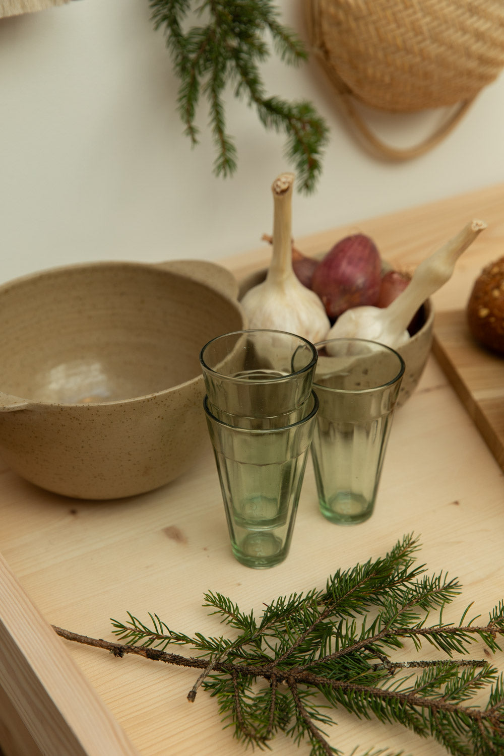Glass tumblers on a wooden kitchen worktop with a rustic background