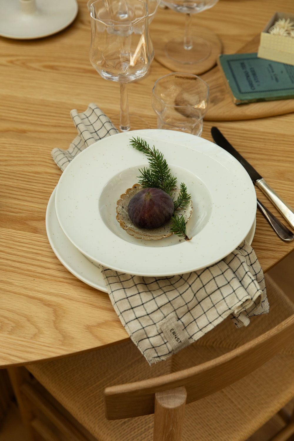Dinner setting with a plate of food on a wooden table