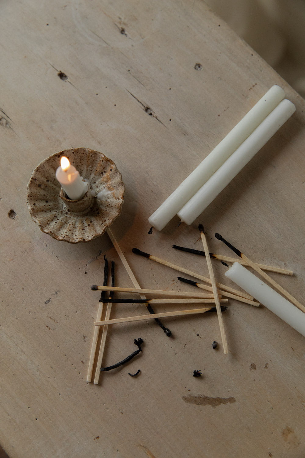 Candle and matches on a wooden surface