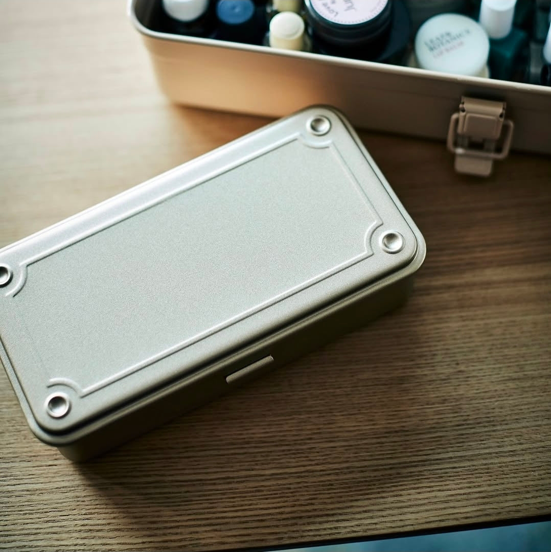 Metal toolbox on a wooden surface with a blurred background