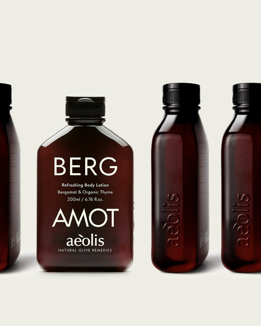 Aeolis bergamot body lotion beside other amber bottles