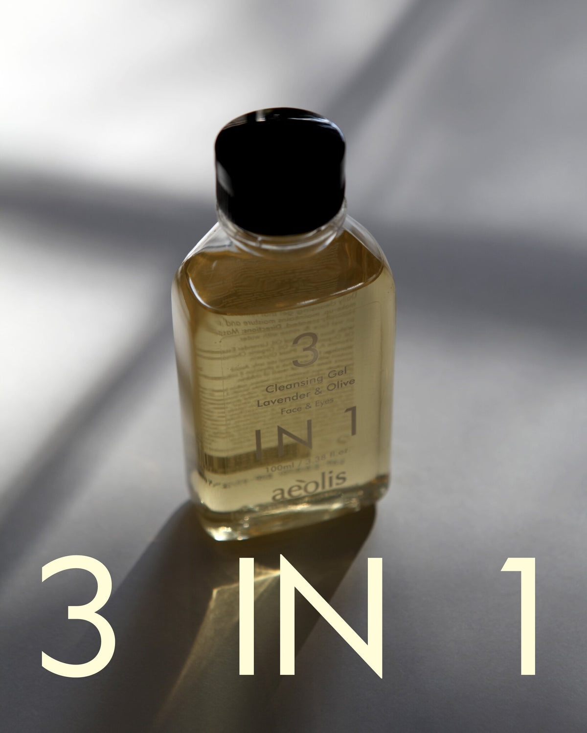 Clear bottle of Aeolis cleansing gel in soft window light