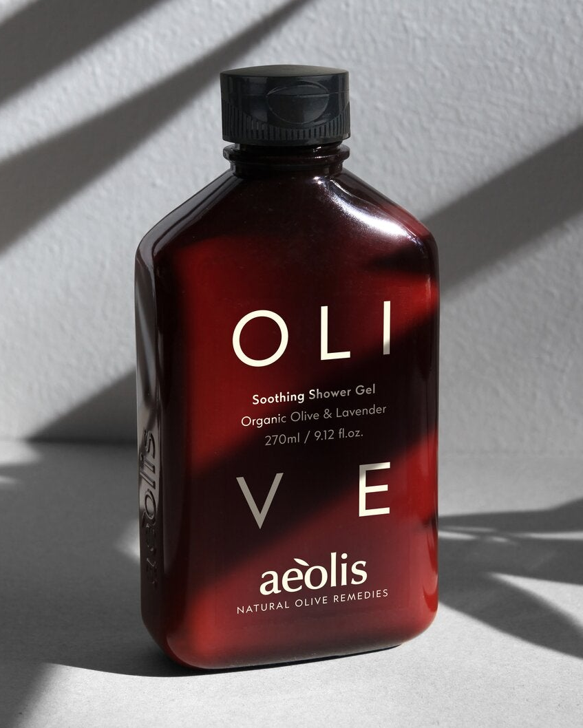 Aeolis olive and lavender shower gel in sunlight with leaf shadows