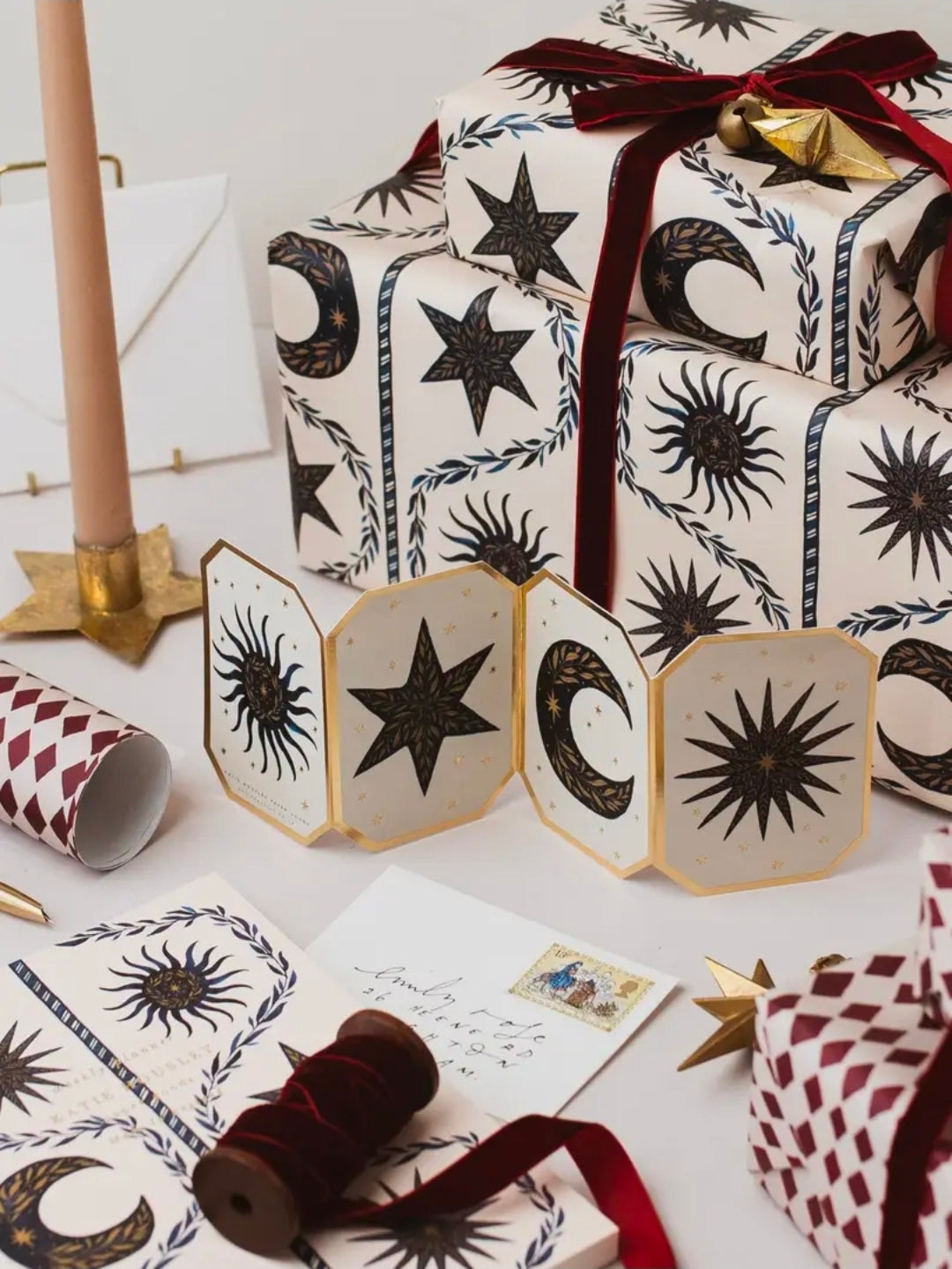 Presents in celestial gift wrap with the matching celestial concertina card and a candle