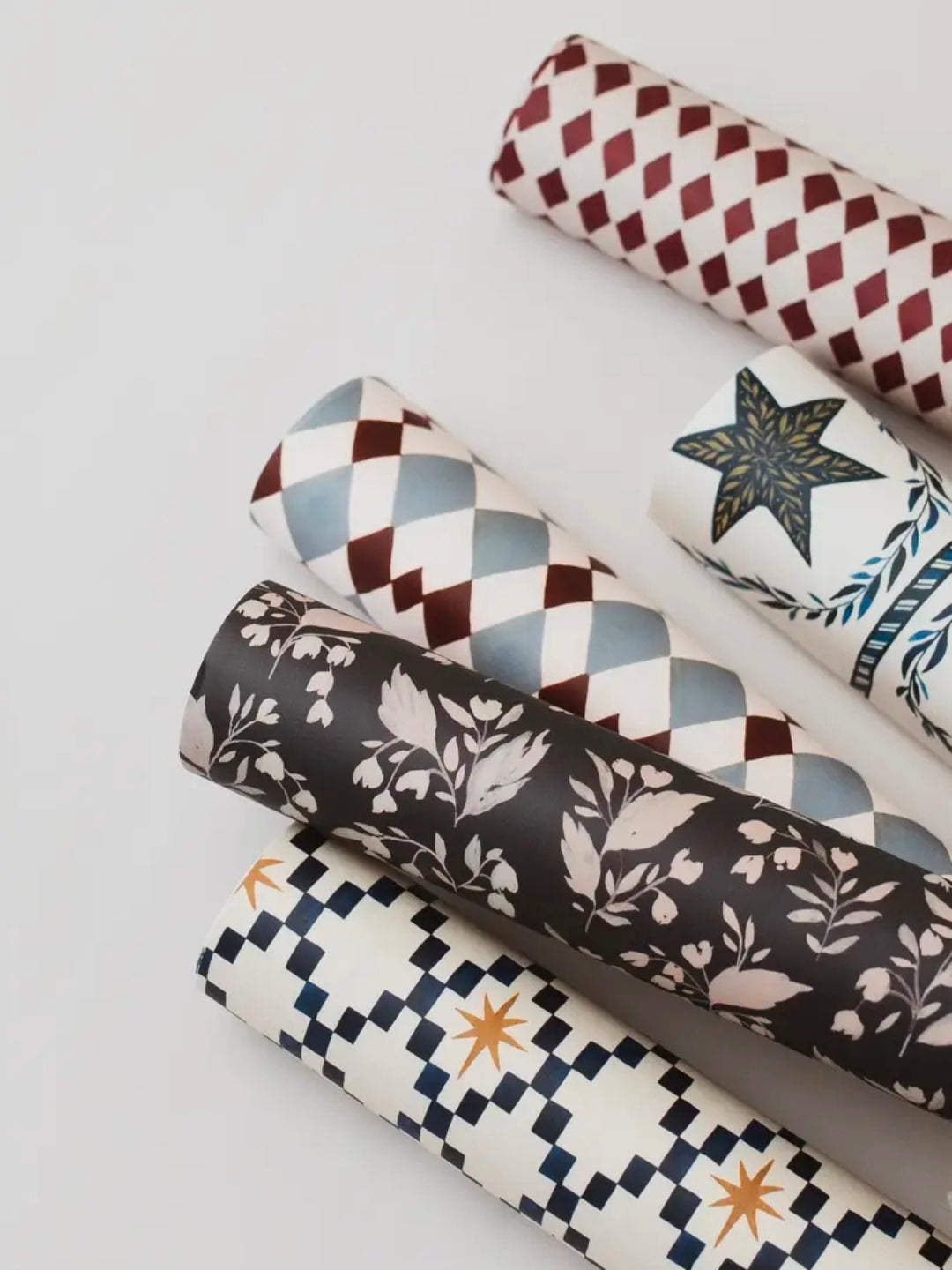 Rolls of Katie Housley gift wrap, including the celestial design