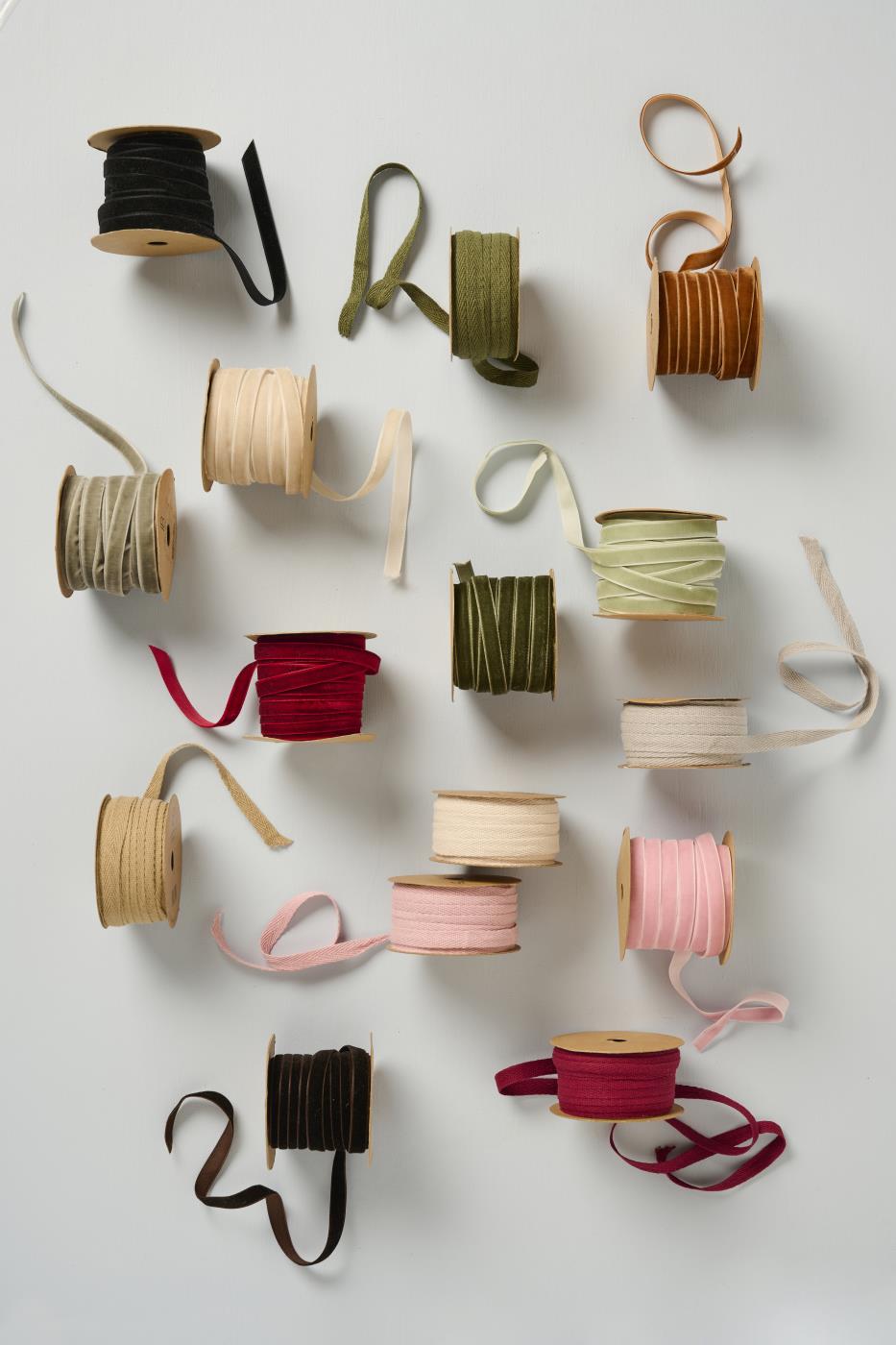 Velvet ribbon spools in a range of colours laid out flat