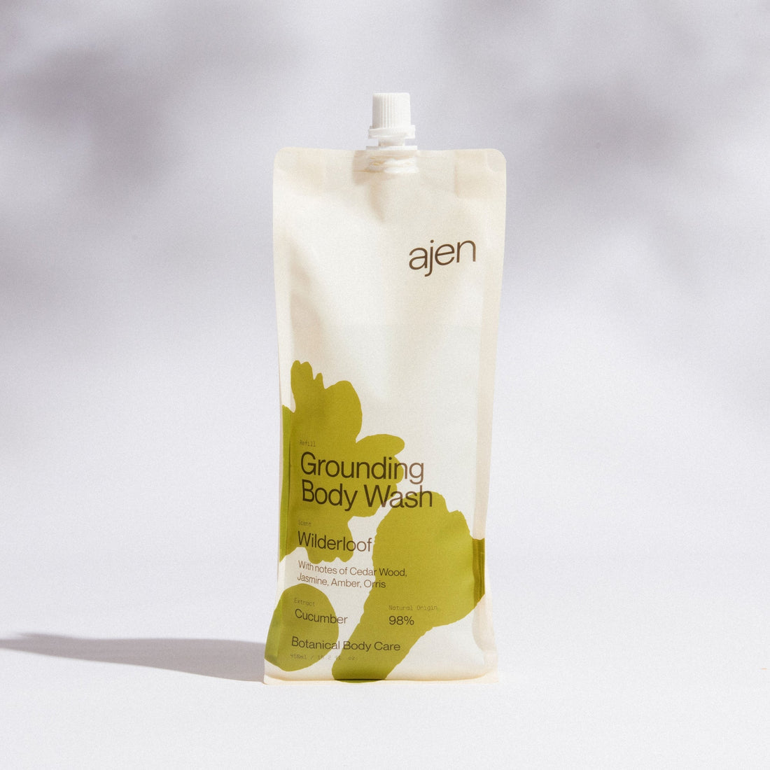 Ajen Grounding Wilderloof Body Wash packaging with green abstract design on a gray background.