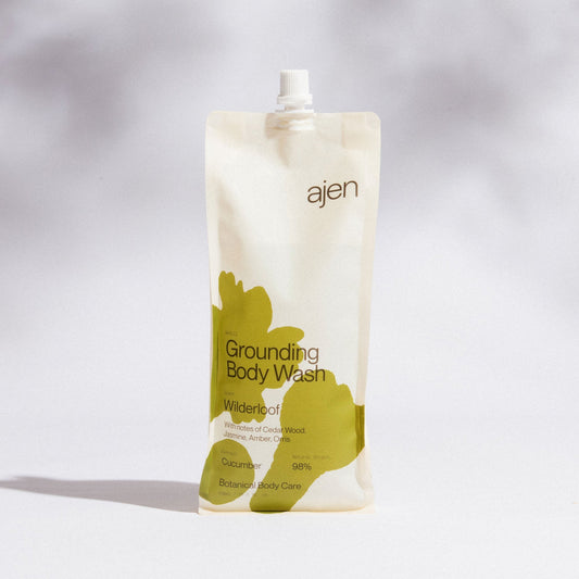 Ajen Grounding Wilderloof Body Wash packaging with green abstract design on a gray background.