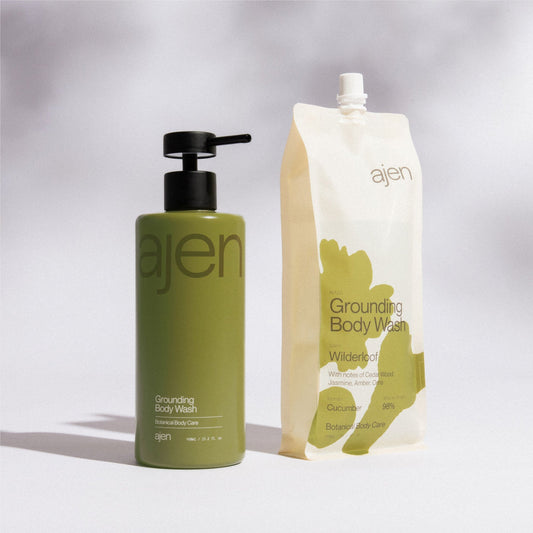 Ajen staineless steel green bottle Green bottle and Wilderloof refill pouch stood next to each other against a light gray background. 