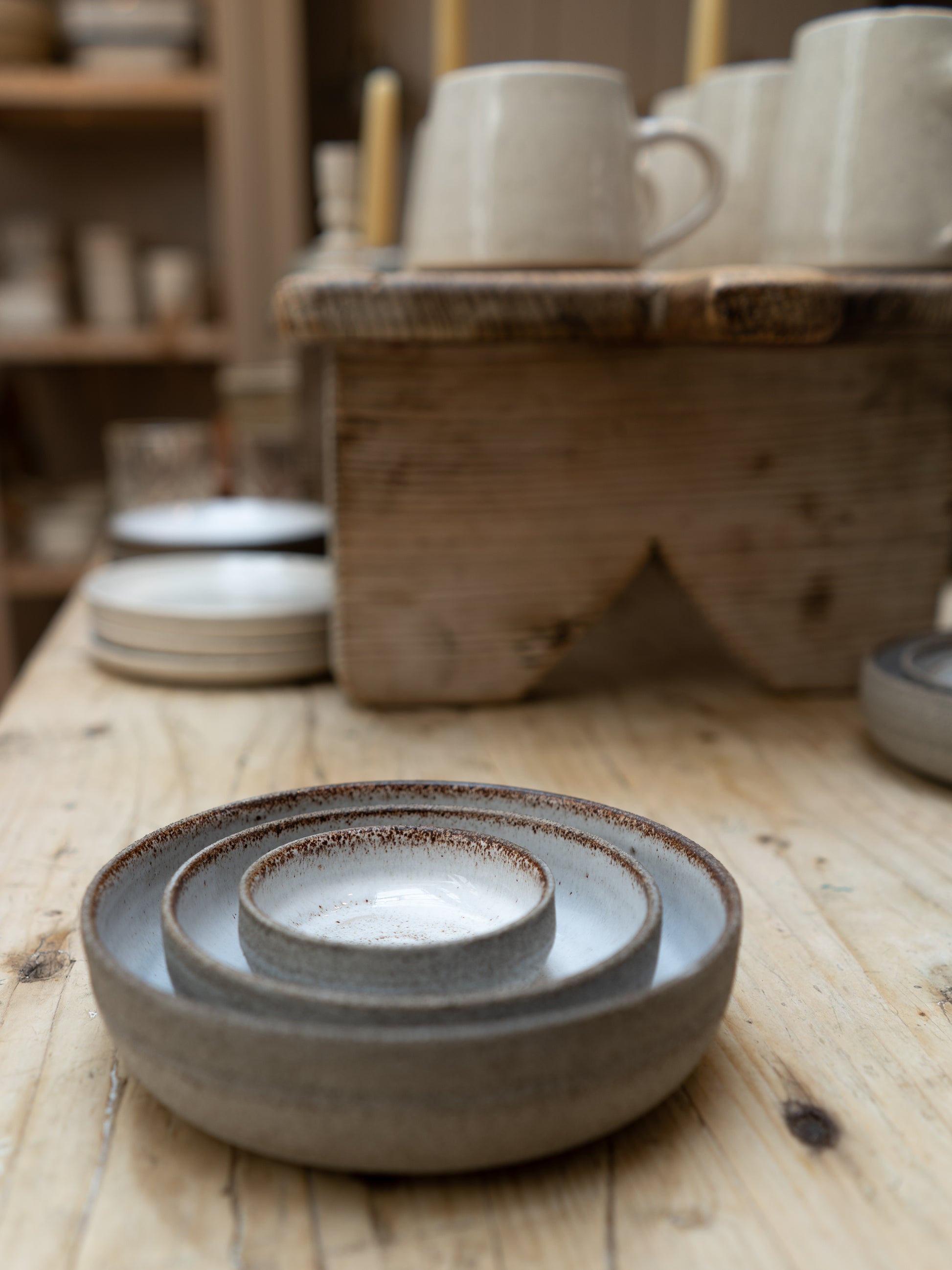 Ceramic bowls on a wooden surface with a rustic background