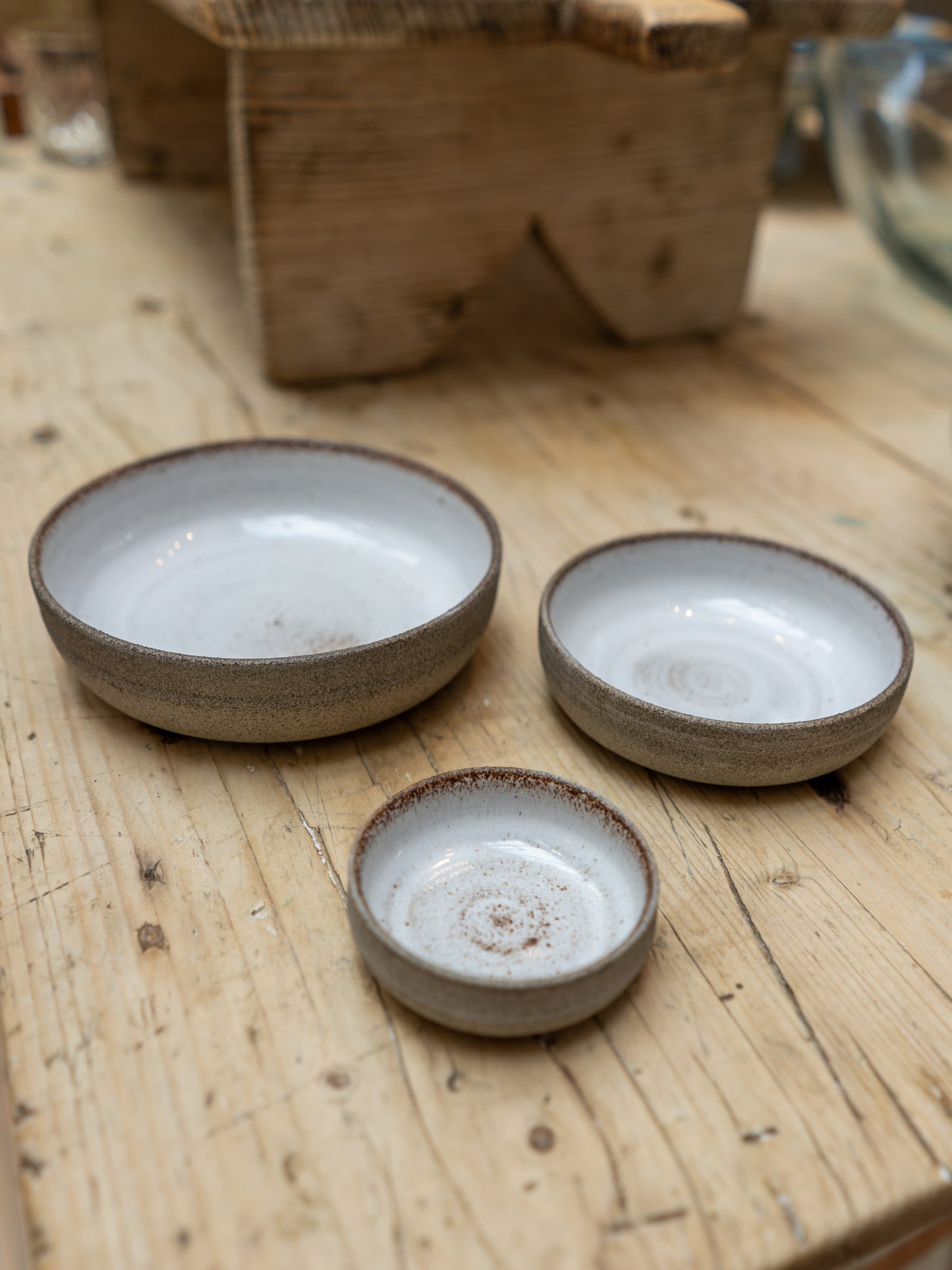 Three ceramic bowls on a wooden surface
