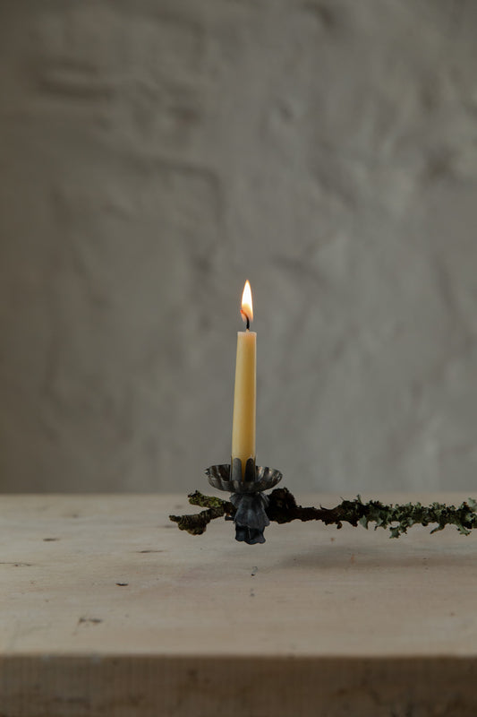 Clip on Candle on a branch with a textured wall background