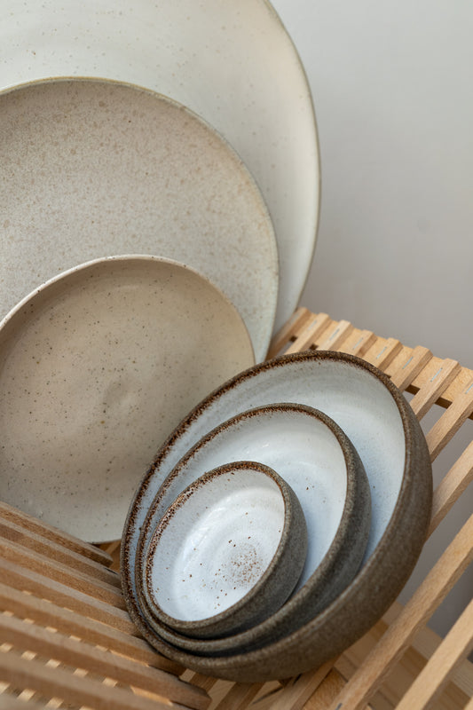 Set of ceramic bowls on a wooden surface