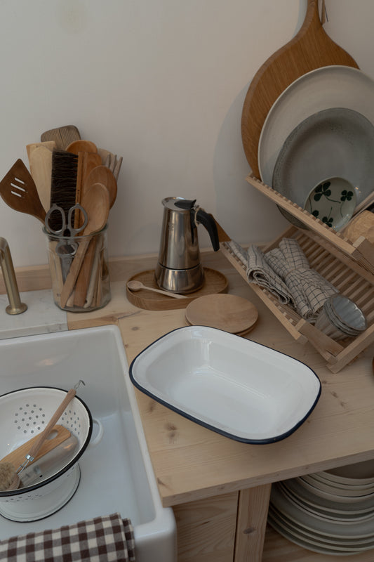 Kitchen counter with dishes, utensils, and a small stove.