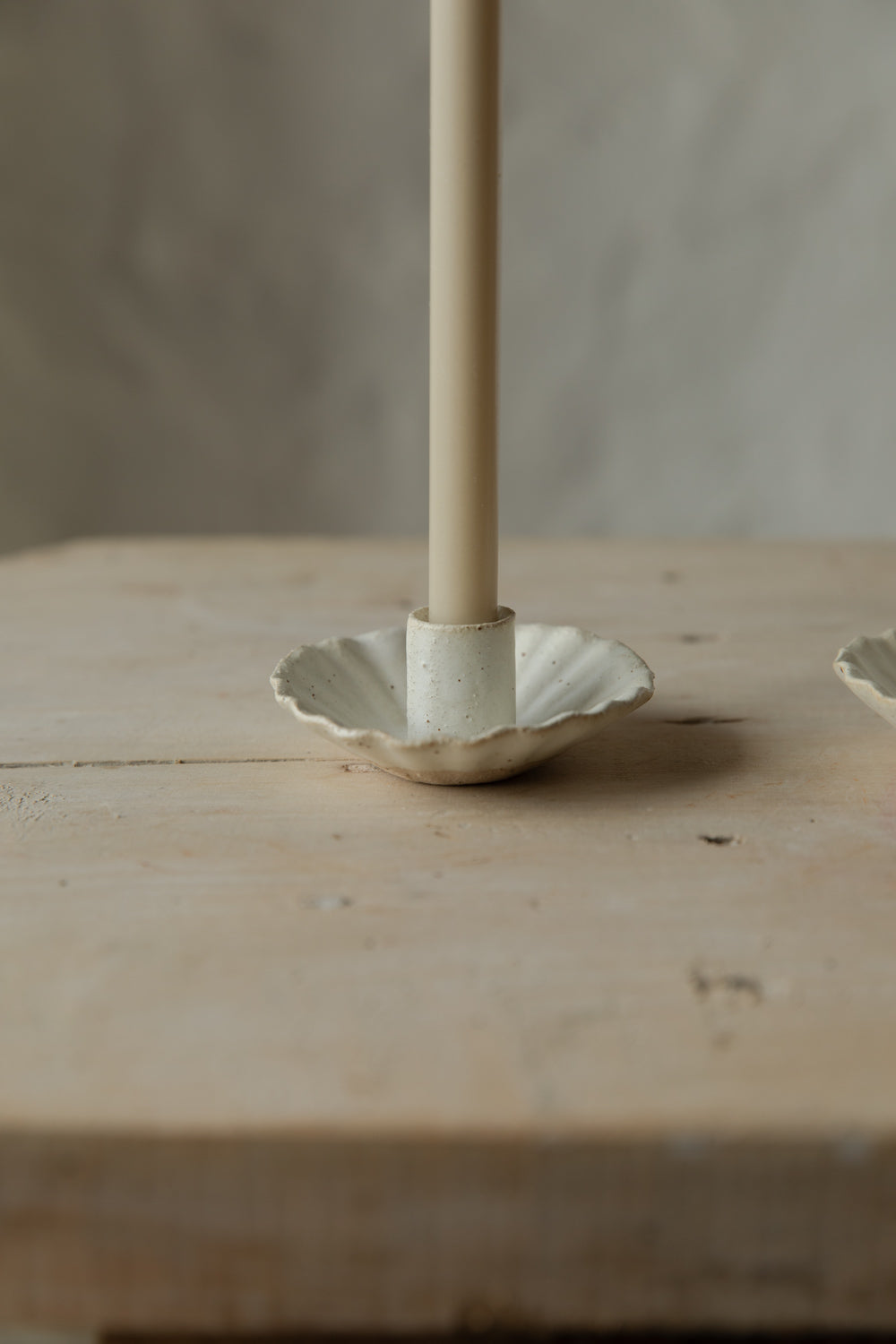 Candle holder base on a wooden surface.