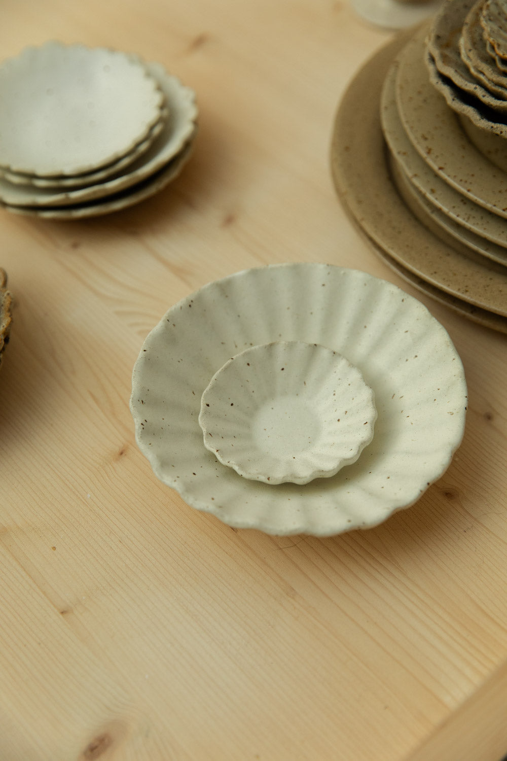 Set of fluted ceramic bowls on a wooden surface.