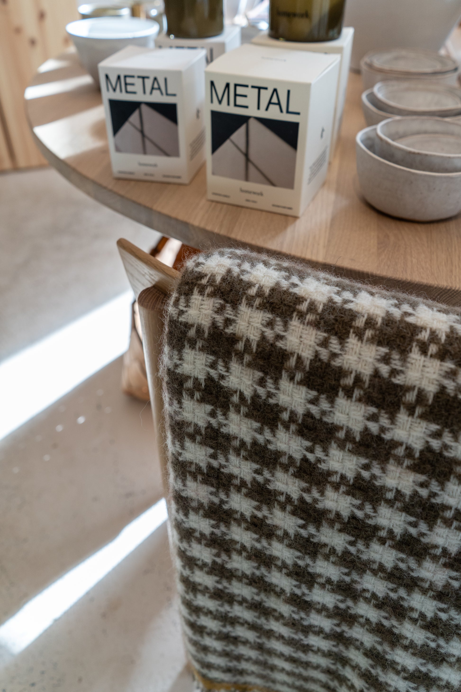 Two boxes labeled 'Metal' on a wooden table with a checkered fabric in the foreground.