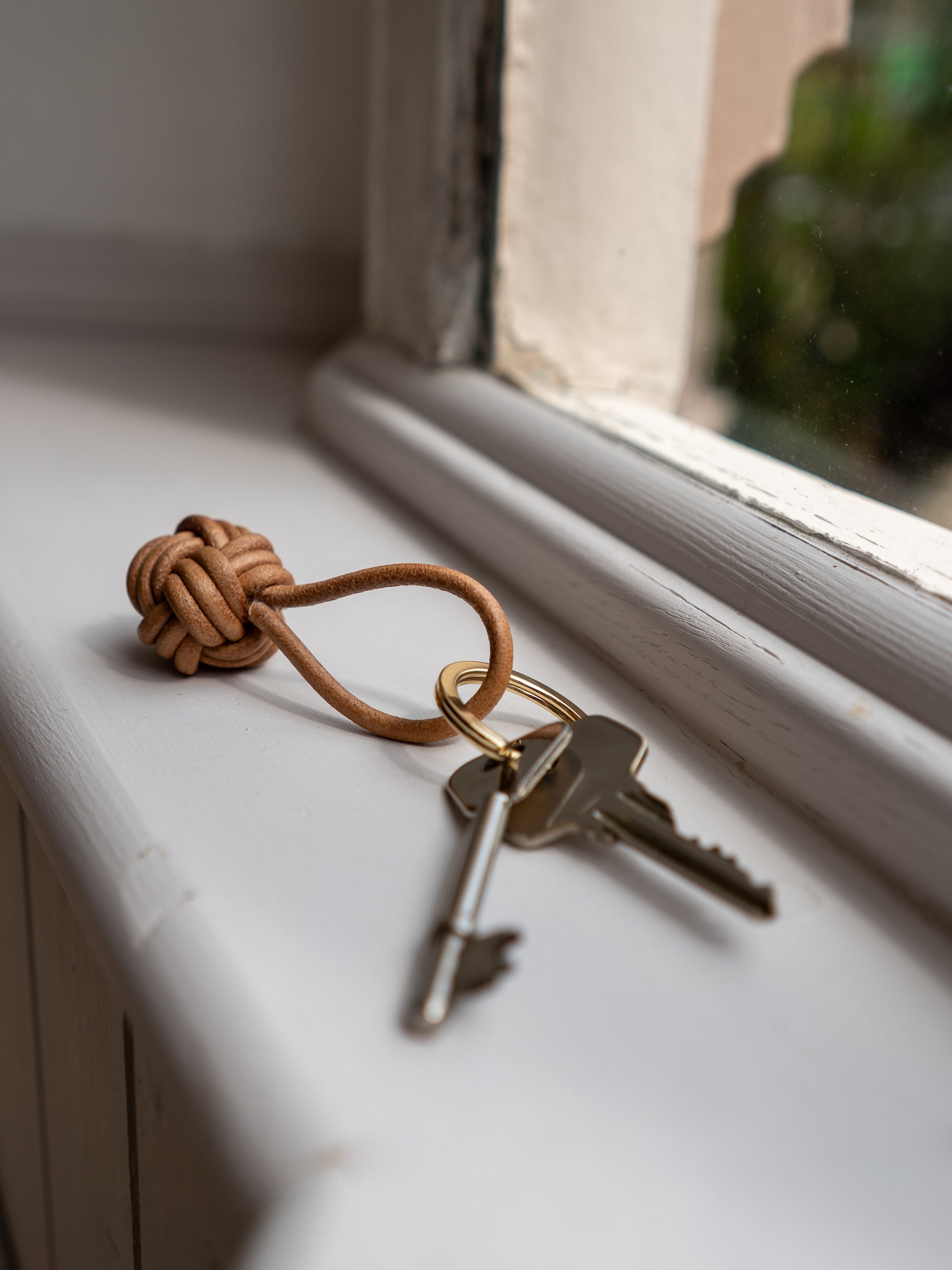 Leather knot keyring with keys on a windowsill