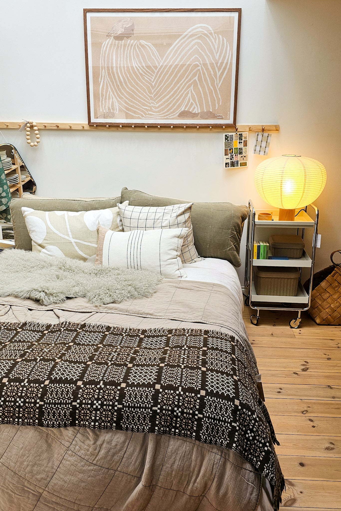 Cozy bedroom with a bed, nightstands, and wall art