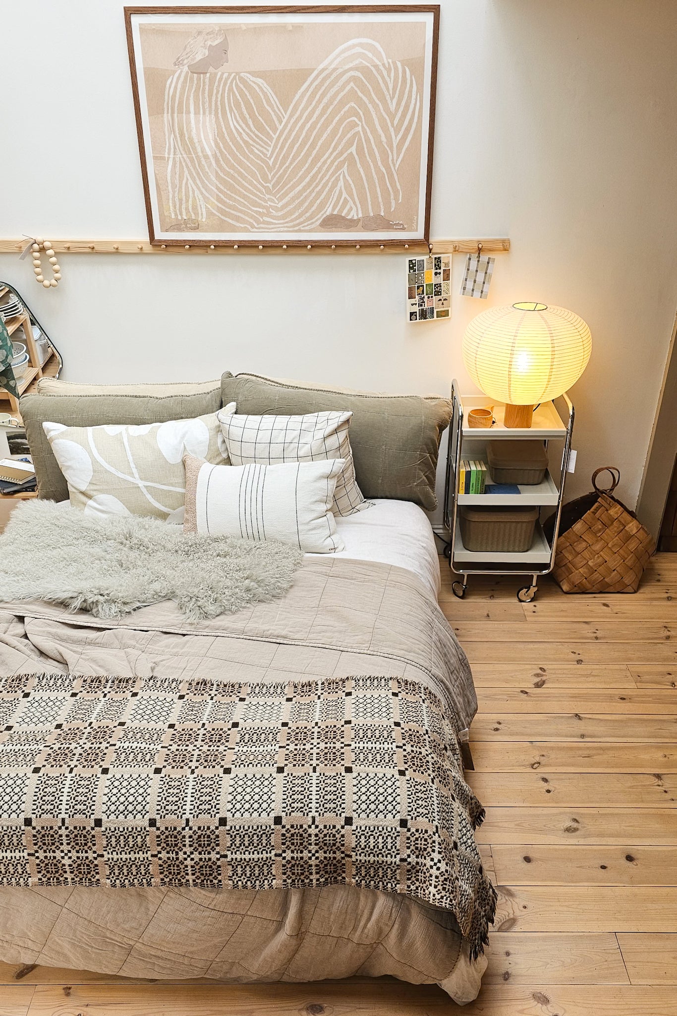 Cozy bedroom with a bed, nightstands, and wall art.