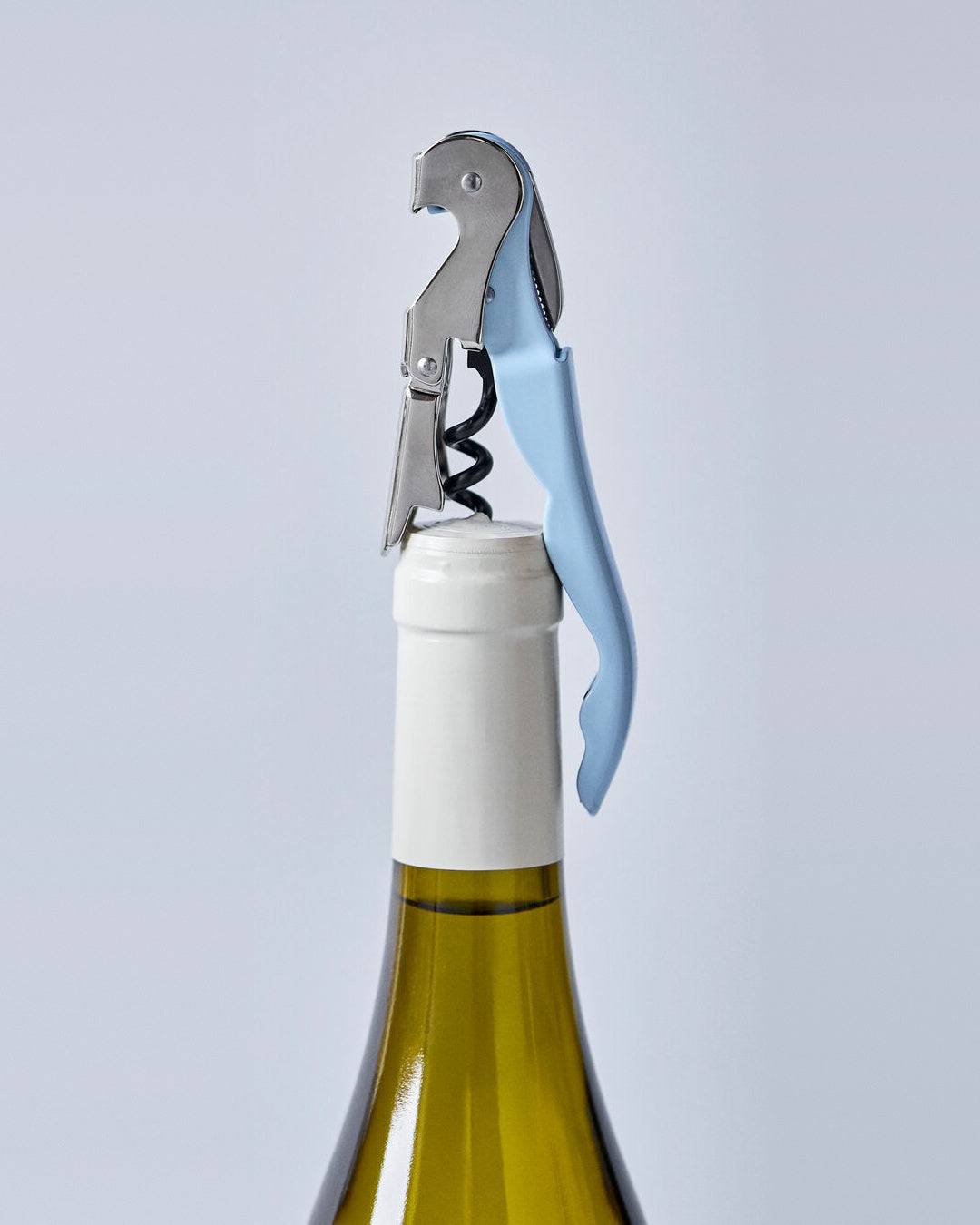 Light blue Nicolas Vahé waiter's friend bottle opener on a wine bottle