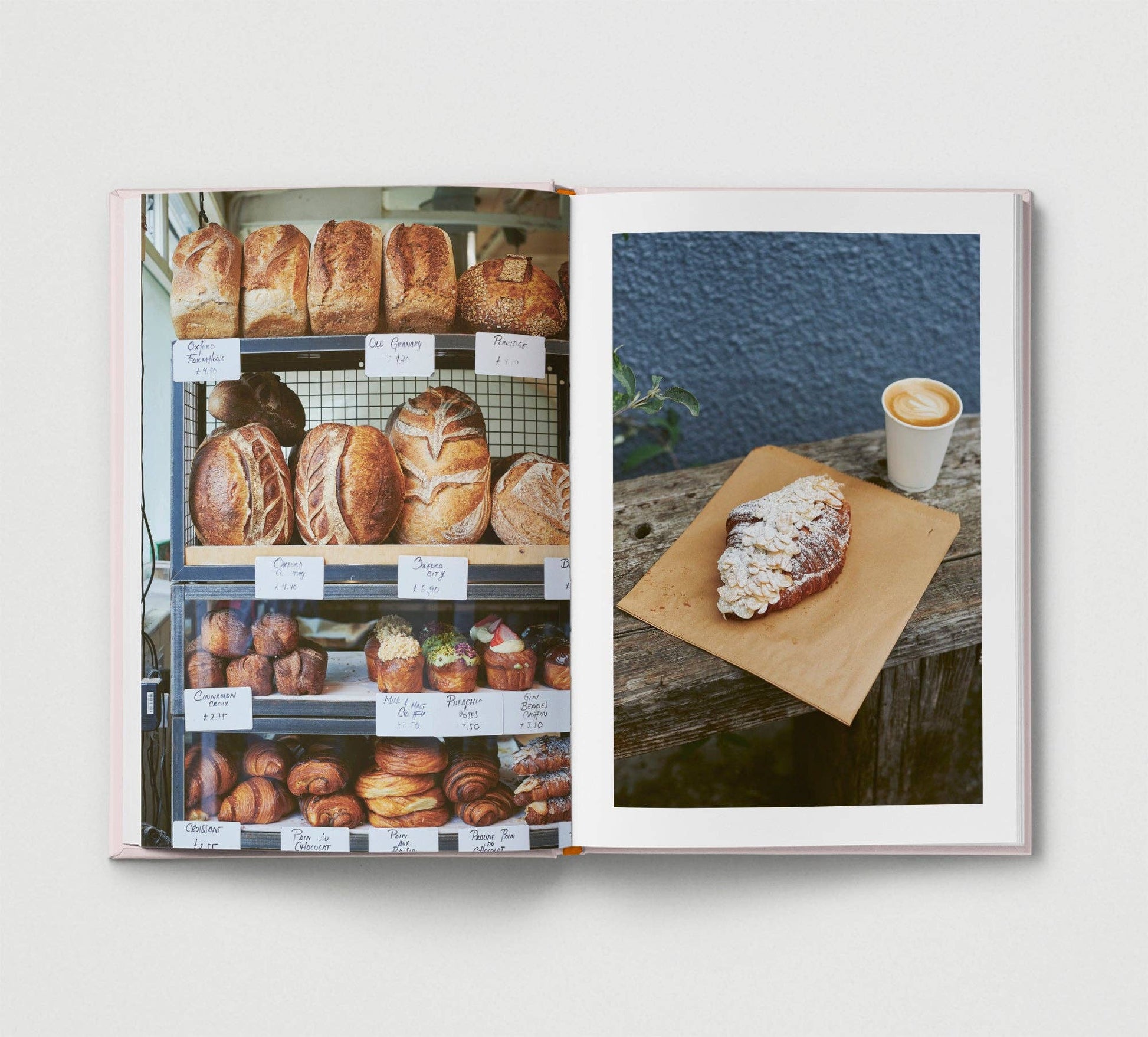Open book showing images of bread and a pastry with a cup of coffee.