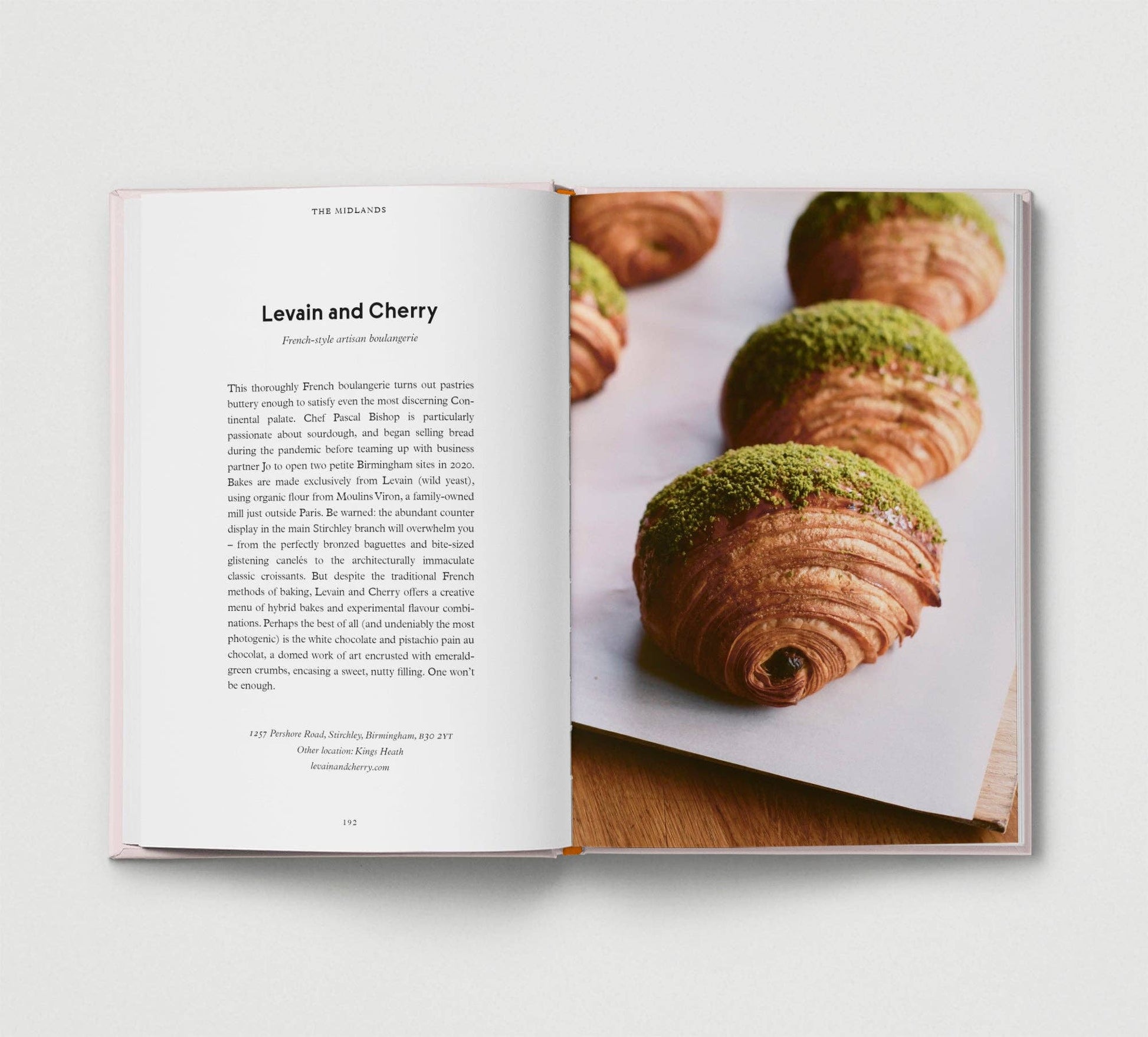 Open book showing a page with text and an image of pastries on a white background.