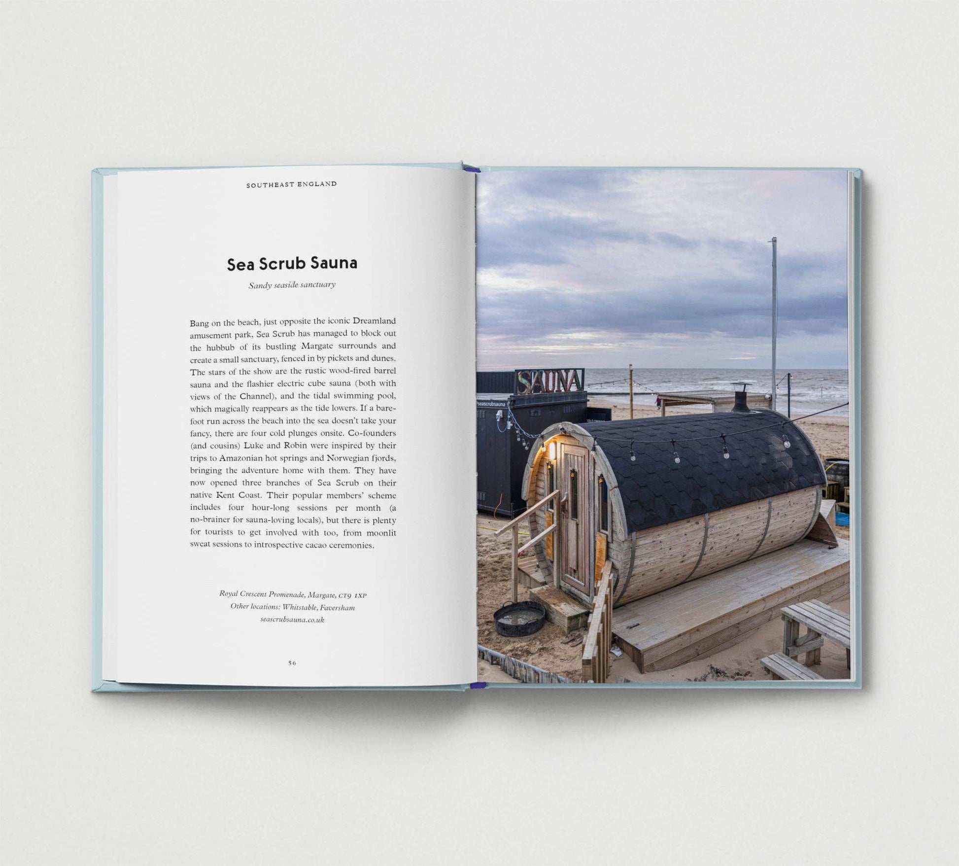 Open book showing a photograph of a sea scrub sauna on a beach with text.