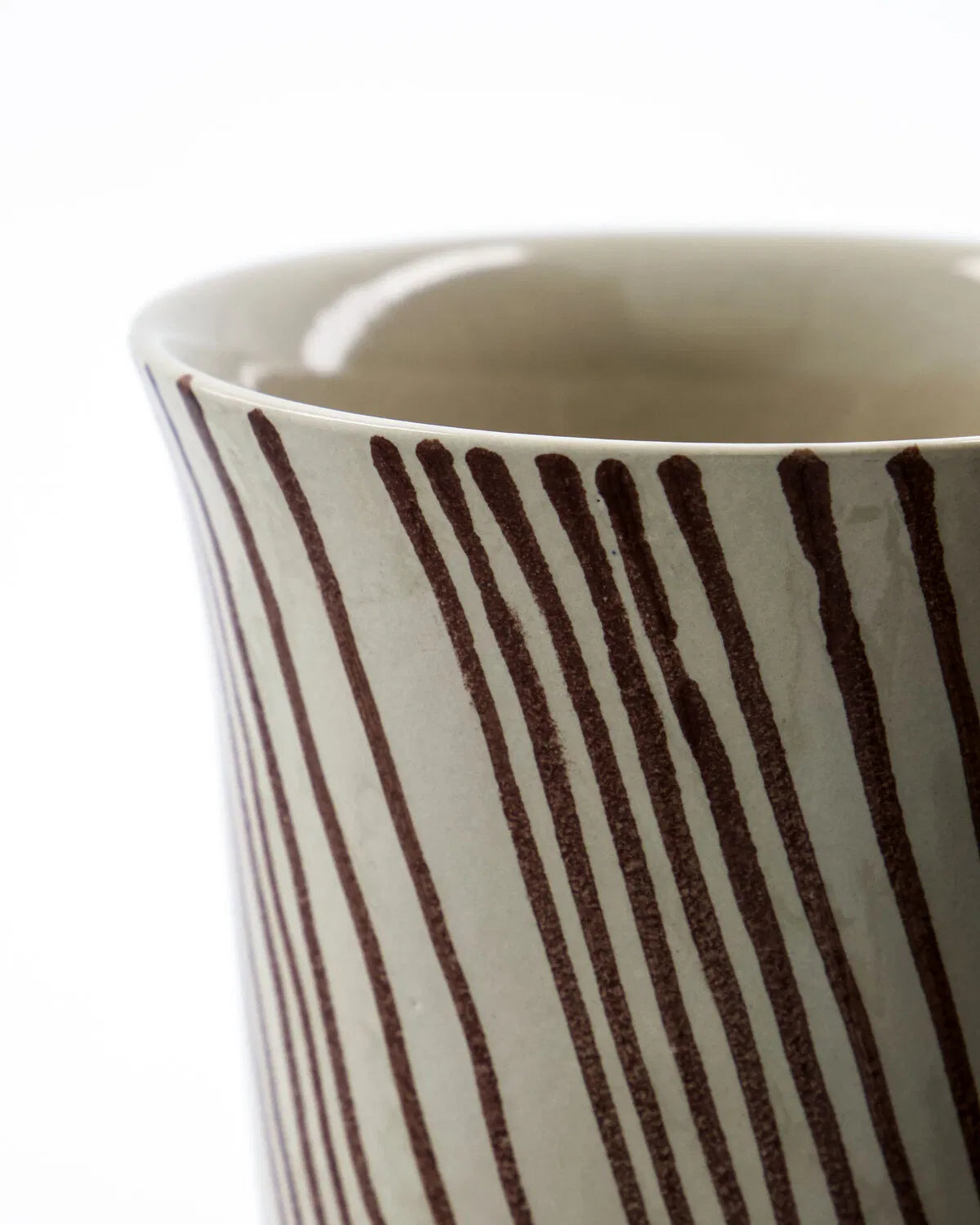 Close up of the hand-painted brown striped on a Diva Mug. Set against a white background.