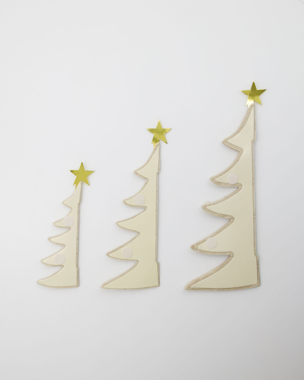 Paper Christmas tree ornaments folded flat for storage