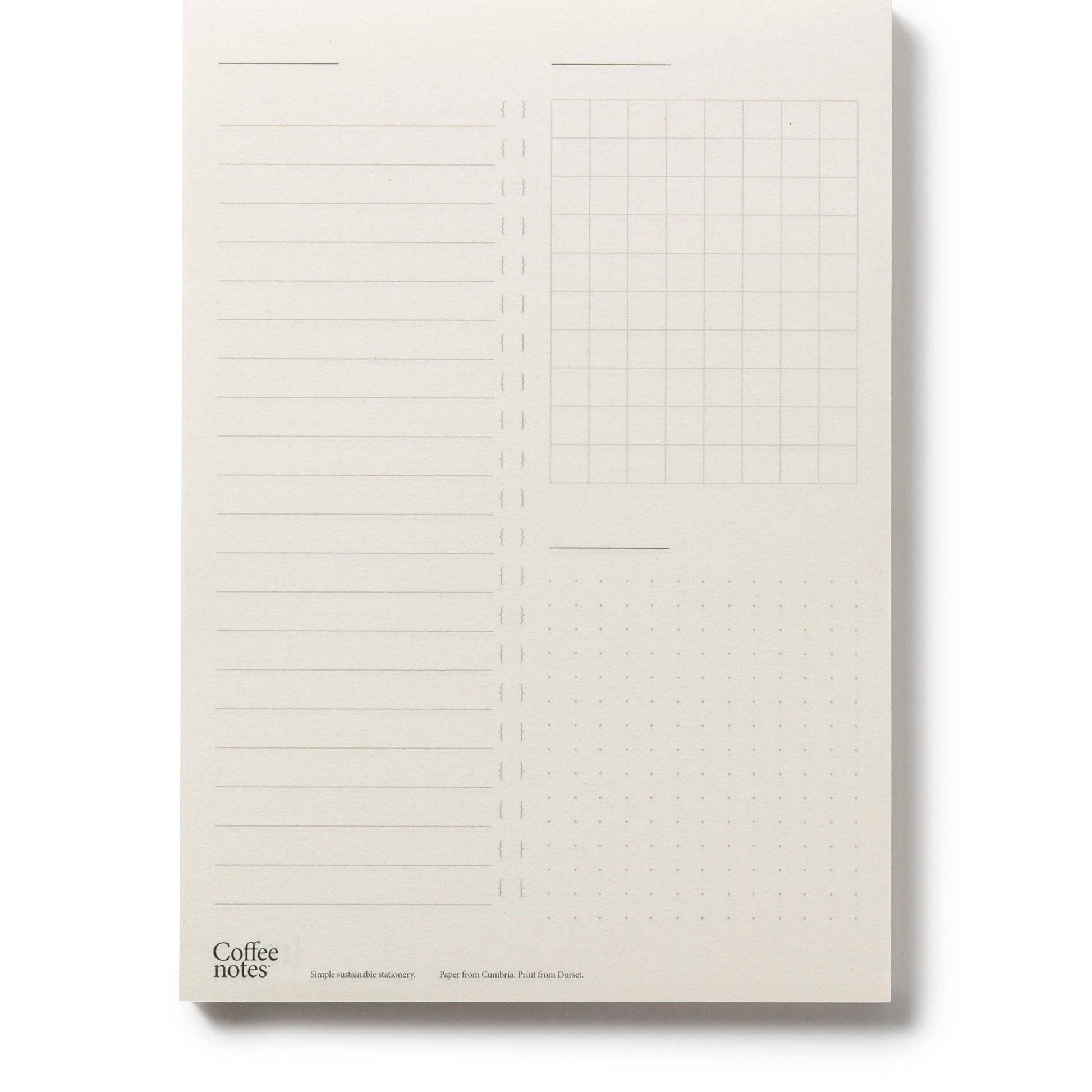Notebook with lined and grid pages on a plain background.