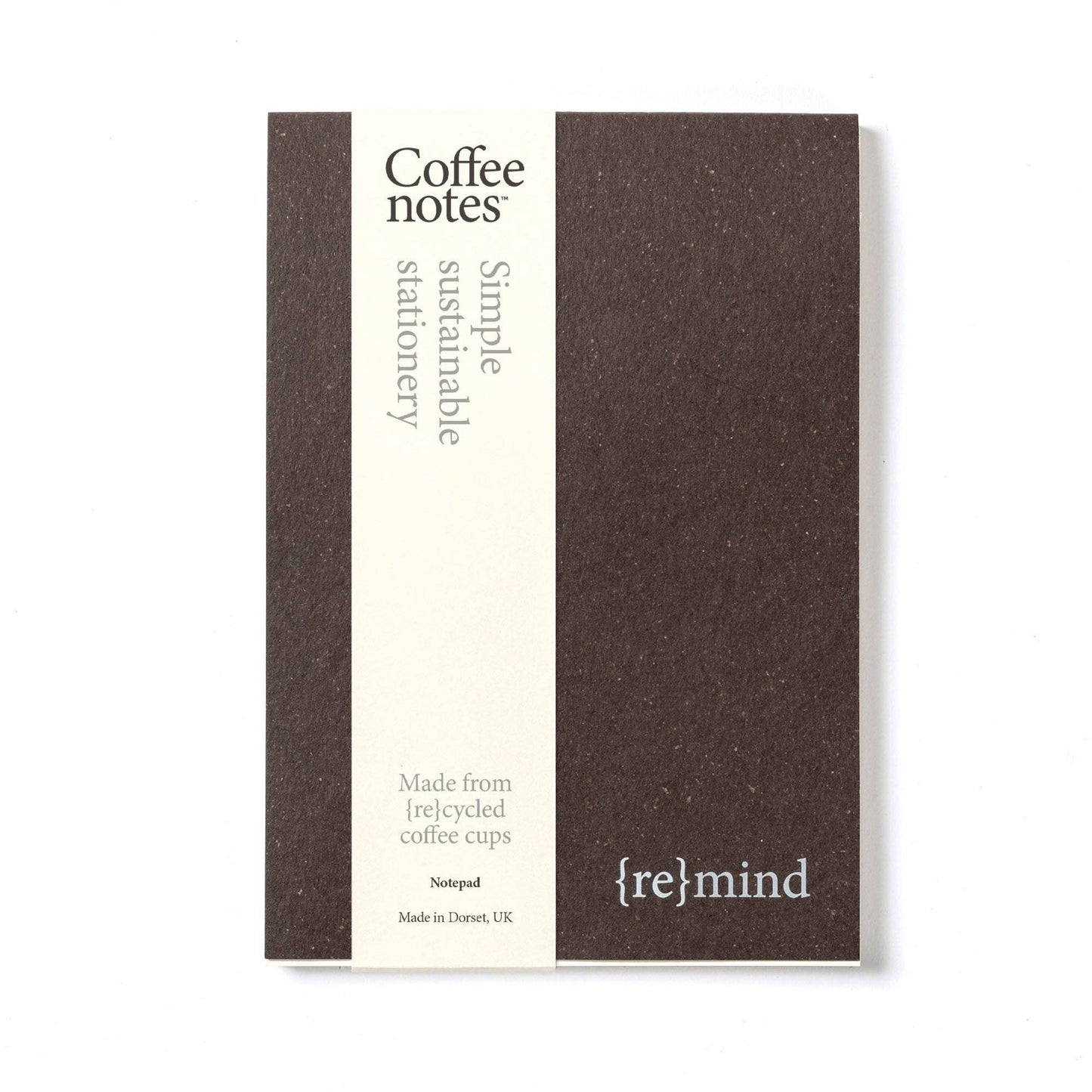 A brown organiser pad with the text 'Coffee notes' and '{re}mind' on the cover, indicating it is made from recycled materials.