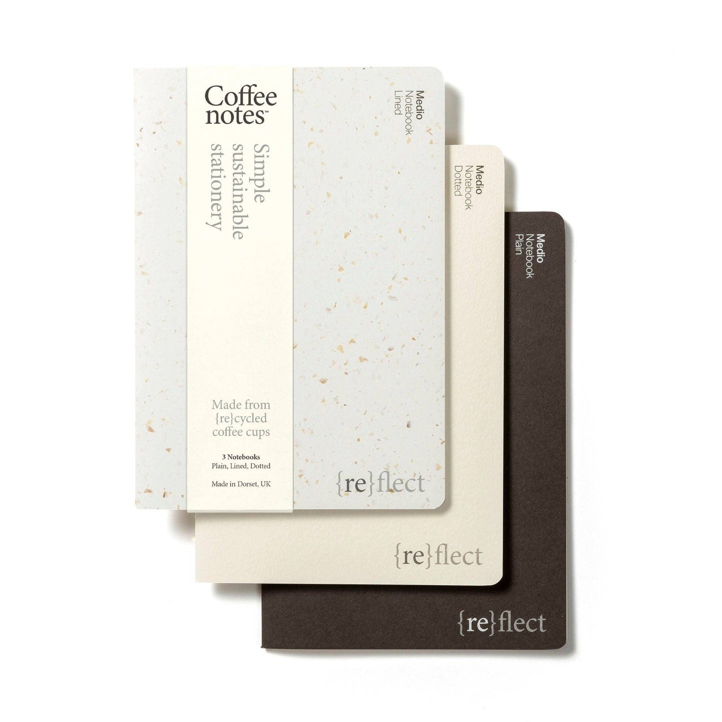 Three notebooks with saddle stitch binding, featuring the text 'Coffee notes' and branded with 'refill'. The notebooks are in beige, brown, and white with a speckled pattern.