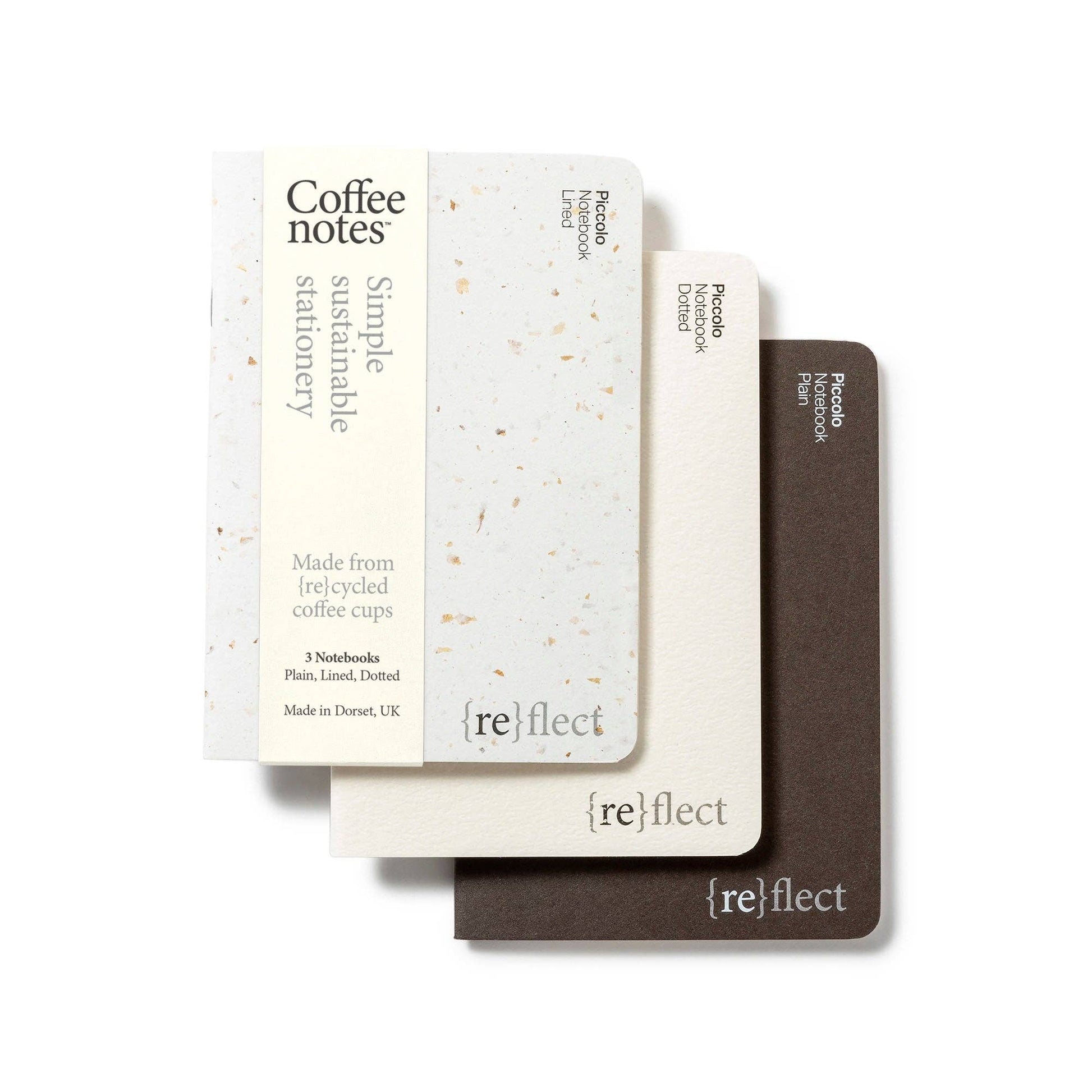 Stack of three notebooks with visible branding and color variations on a plain background.