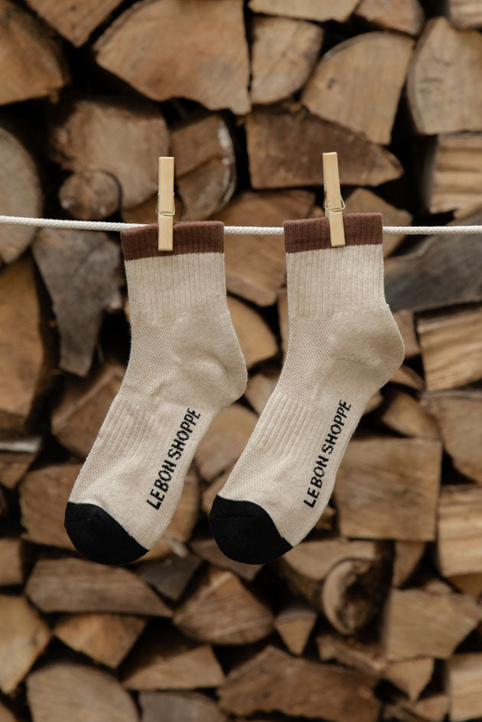 Le Bon Shoppe Girlfriend Socks in Black Coffee, cream with brown cuffs and black toes, pegged against logs