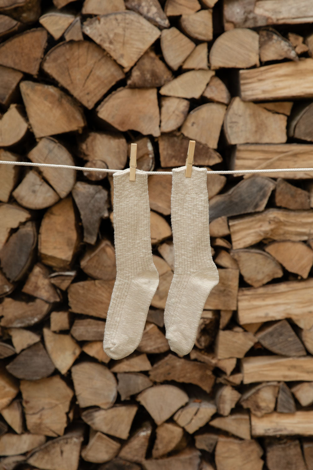 Le Bon Shoppe Cottage Socks in Oatmeal, cream open knit, hanging from wooden pegs